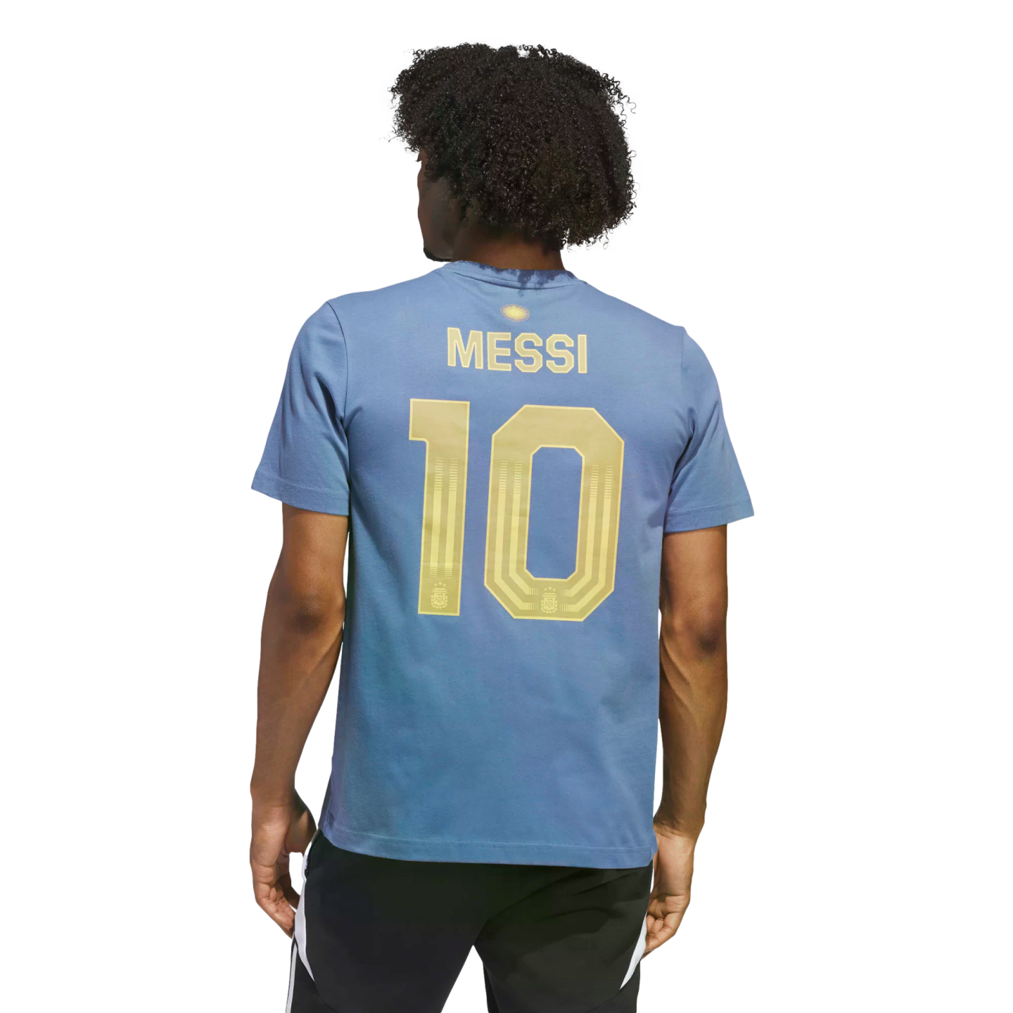 Rear view of a person with dark curly hair wearing a blue t-shirt with gold "MESSI 10" on the back and black athletic shorts, set against a black background.