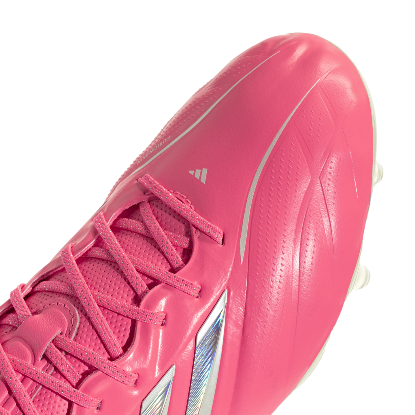 A close-up shot of a bright pink Adidas soccer cleat against a white background, showcasing the laces and textured upper material.
