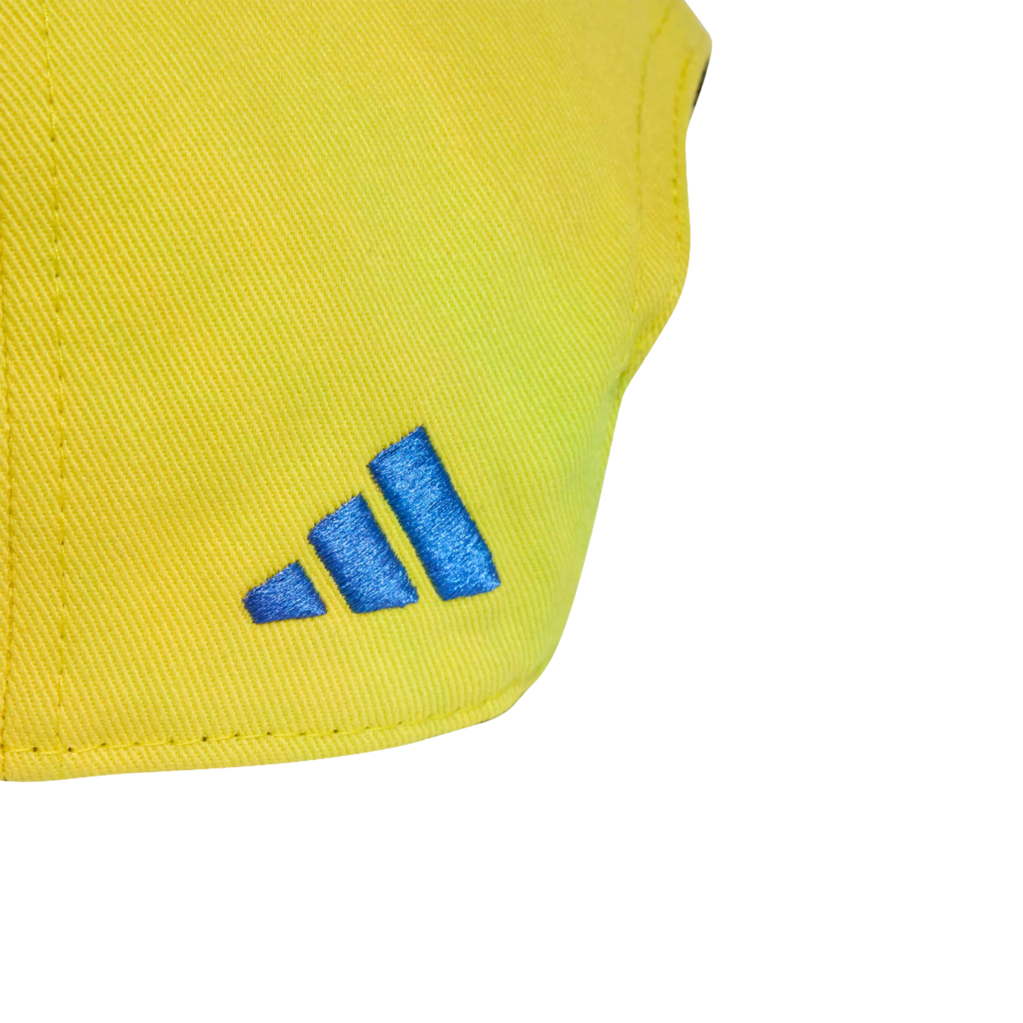 Close-up of a blue Adidas logo embroidered on yellow twill fabric.
