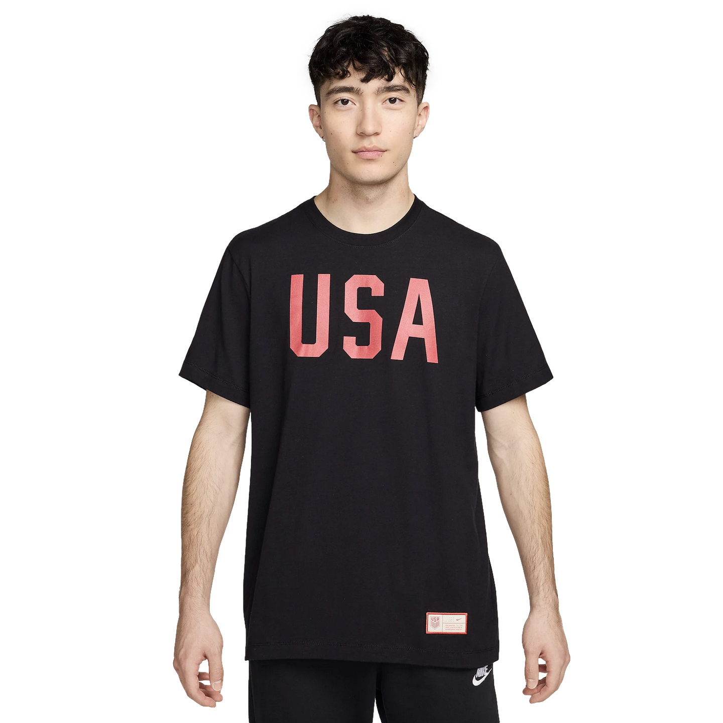 A man wearing a black T-shirt with "USA" in large red letters across the chest, shown against a white background.