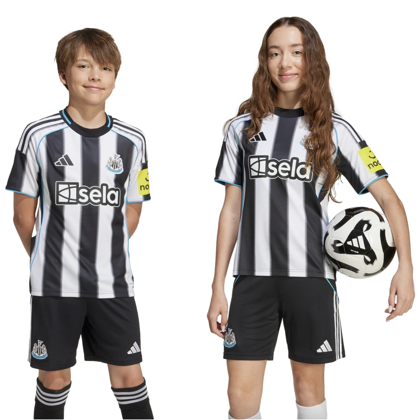 A boy and girl wearing black and white striped Newcastle United home kits smile against a white background. The girl holds a soccer ball. They look directly at the camera.