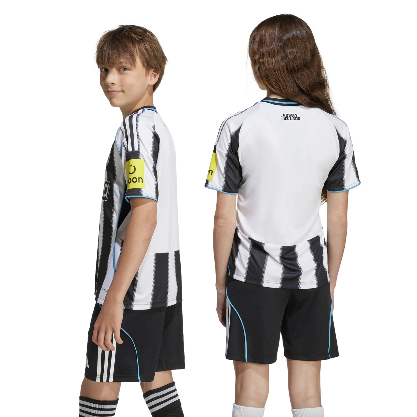 Two youth models wearing a black and white striped soccer kit. The girl displays the back with 'HOWAY THE LADS' text, and the boy faces sideways.