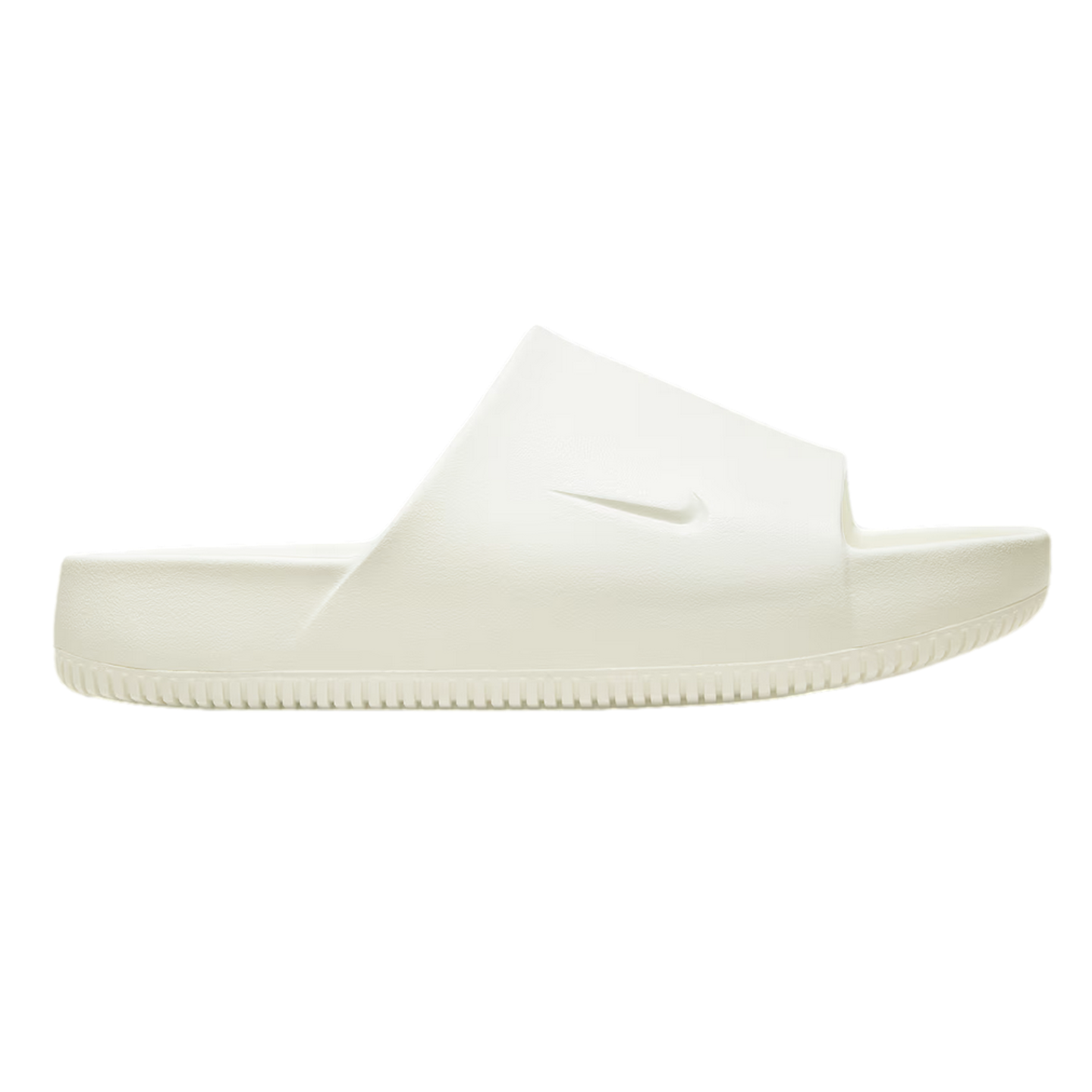 Profile view of a cream Nike slide sandal with a chunky ridged sole and debossed swoosh on the wide strap.