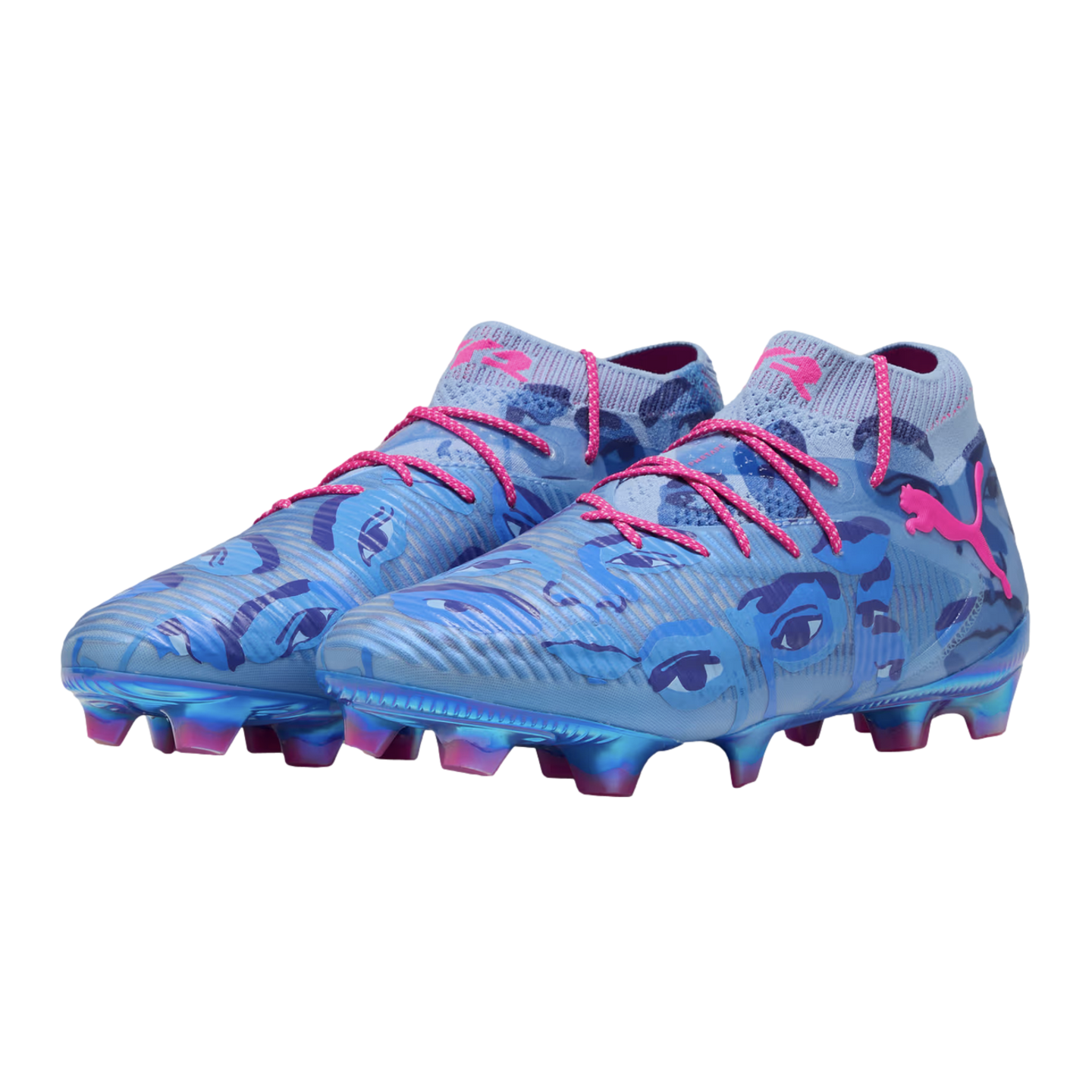 A pair of light blue Puma soccer cleats with dark blue eye graphics, pink laces, and pink logos. The soles feature iridescent blue and pink studs.