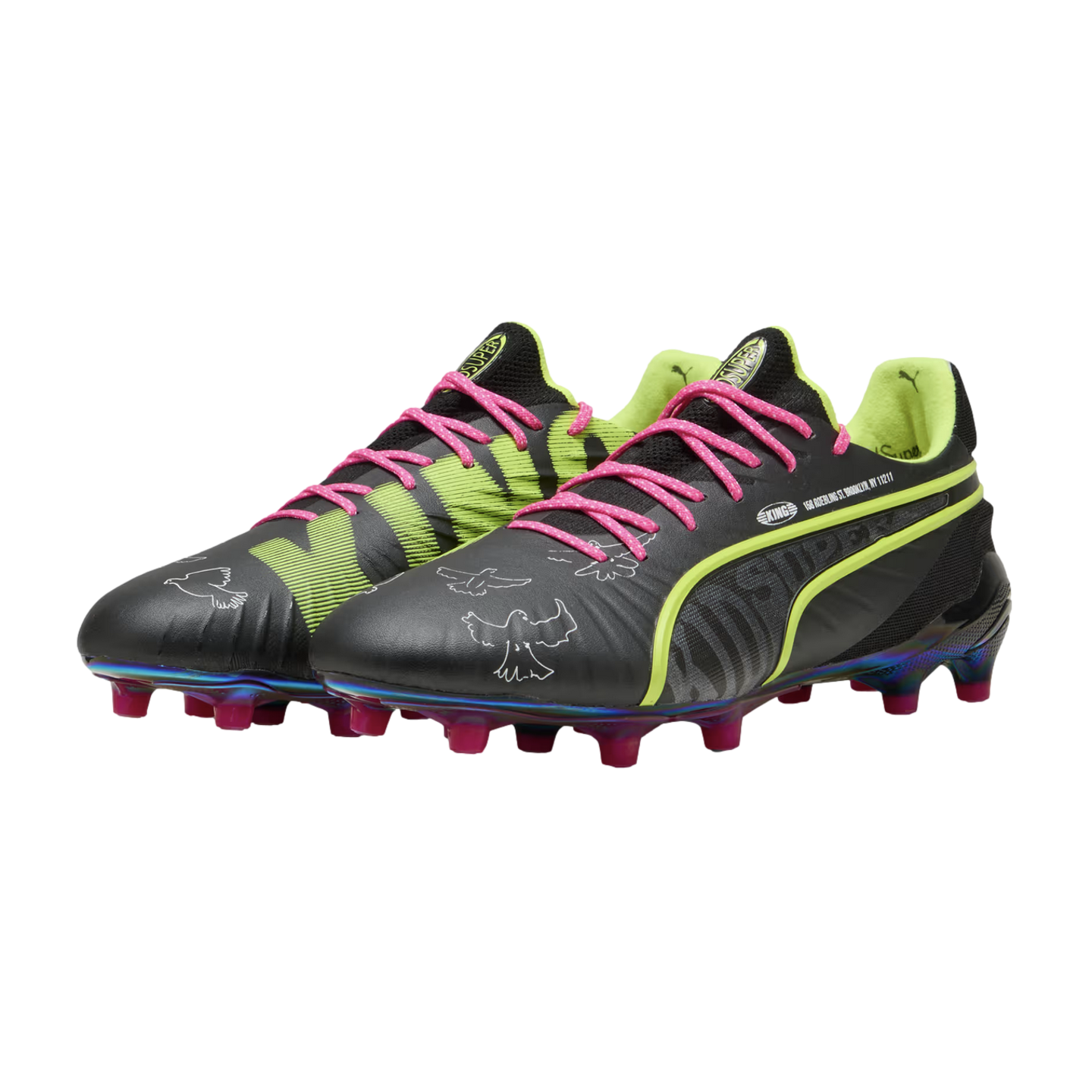 A pair of black Puma King soccer cleats featuring lime green accents, bright pink laces, white pigeon graphics, and an iridescent soleplate with pink studs.