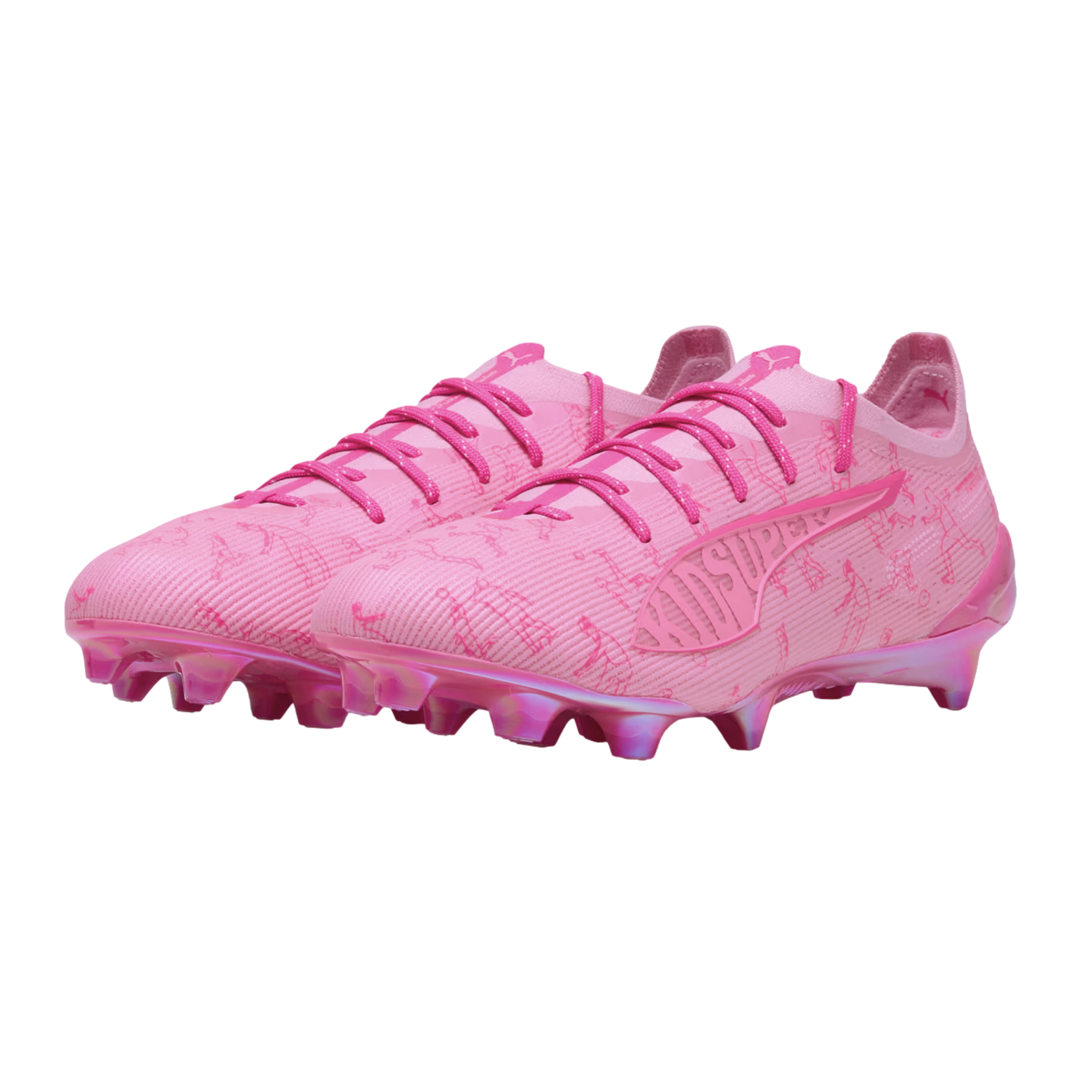 A pair of bright pink Puma x KidSuper soccer cleats with a patterned upper and cleated sole, shown against a white background.