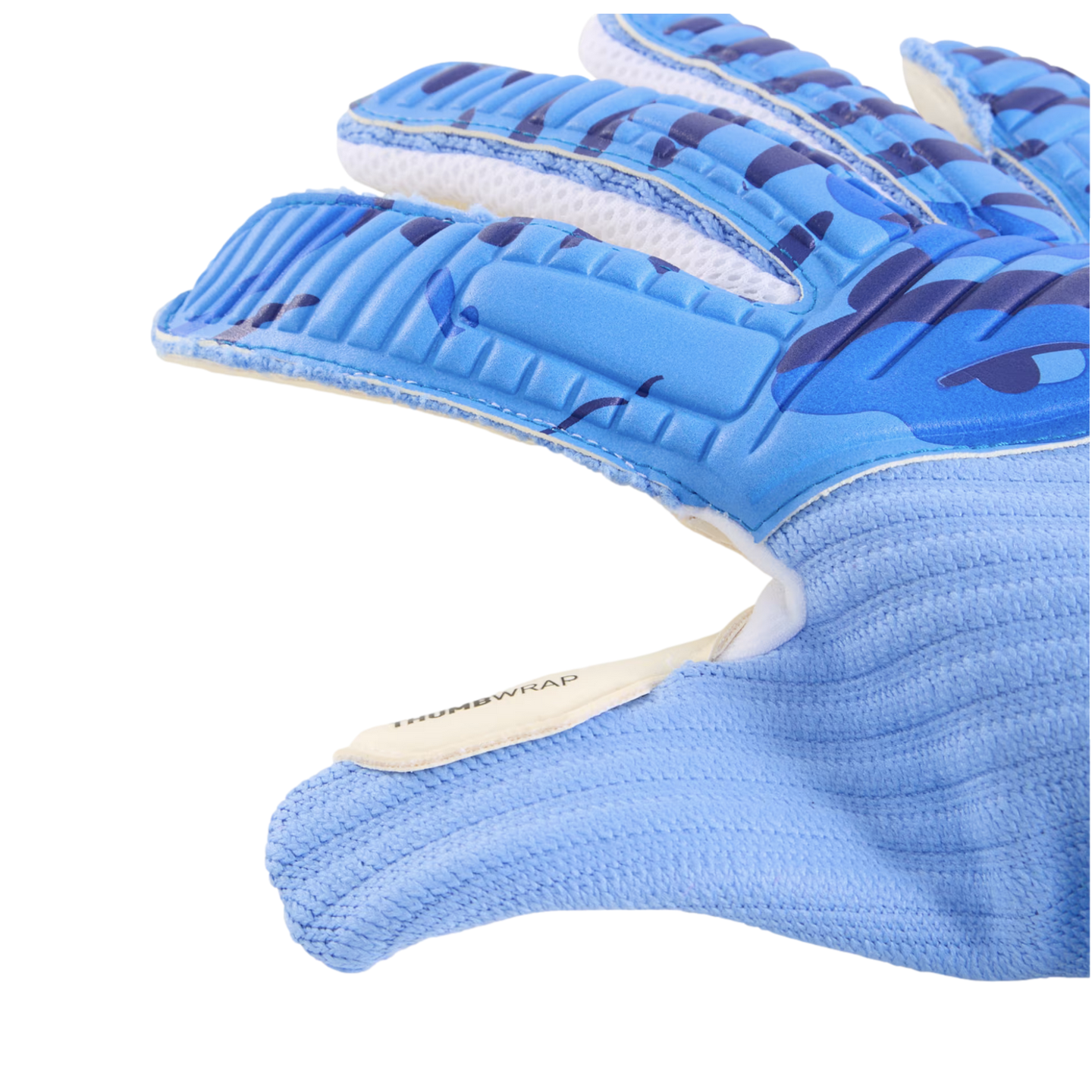 Close-up of a light blue soccer goalkeeper glove featuring textured padding on the fingers and a ribbed wrist. A white tab on the thumb is labeled "THUMBWRAP".