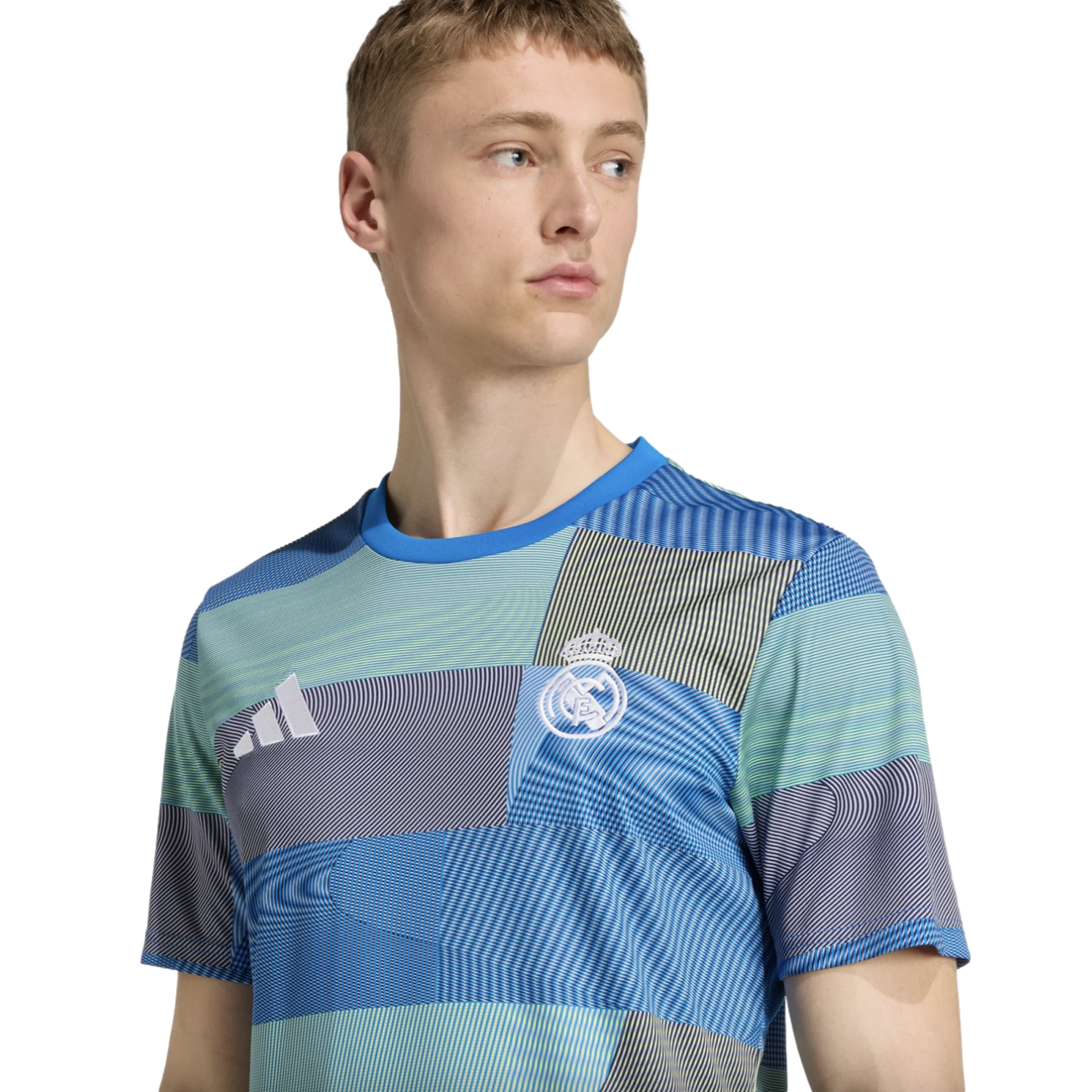 Man wearing a blue and green patterned Real Madrid soccer jersey with the Adidas logo.