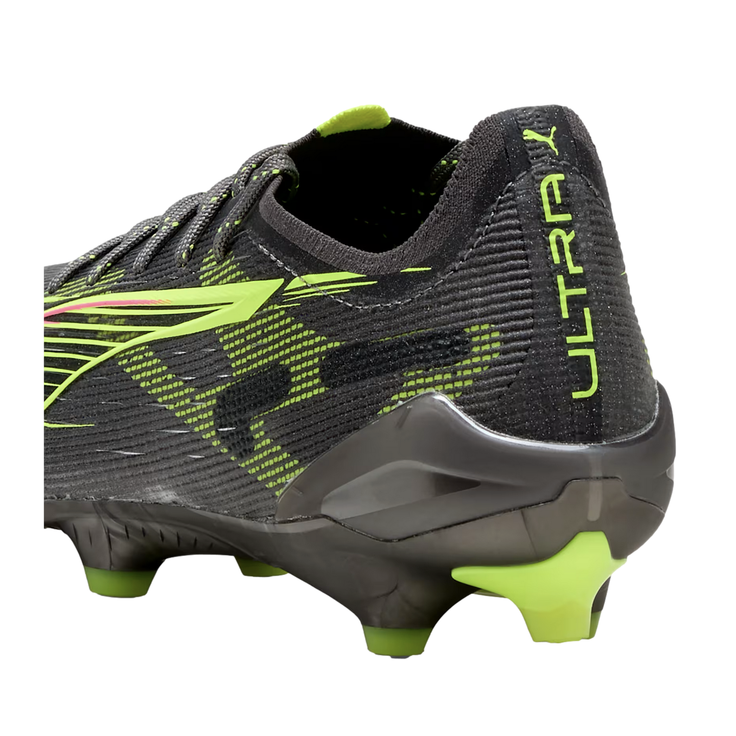 Close-up of a black Puma Ultra soccer boot heel with lime green accents, showing the textured upper, "ULTRA" branding, and studs.