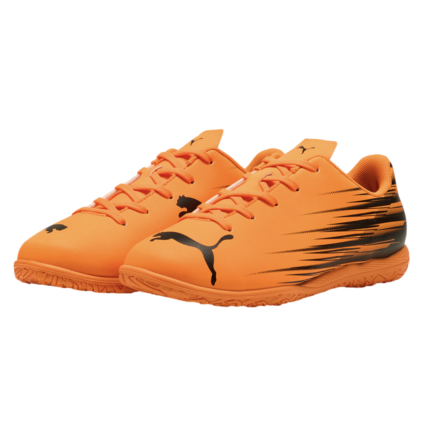 Pair of bright orange Puma indoor soccer shoes with black graphic details and logos, set against a black background.