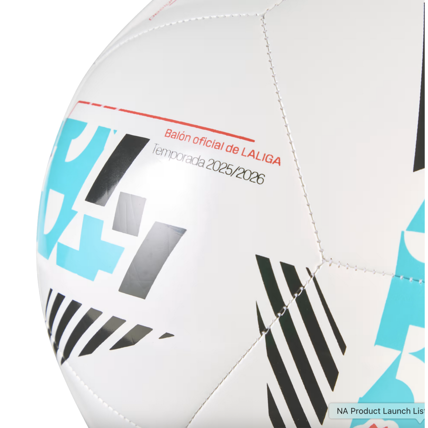 Close-up of a white soccer ball with blue and black geometric patterns and text reading "Balón oficial de LALIGA Temporada 2025/2026."