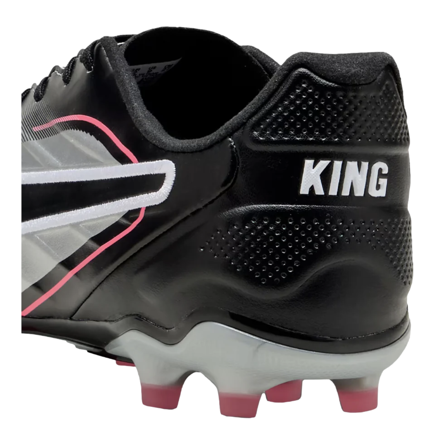 A close-up of the heel of a black PUMA King soccer cleat, featuring silver and pink accents, white "KING" branding, and pink-tipped studs.