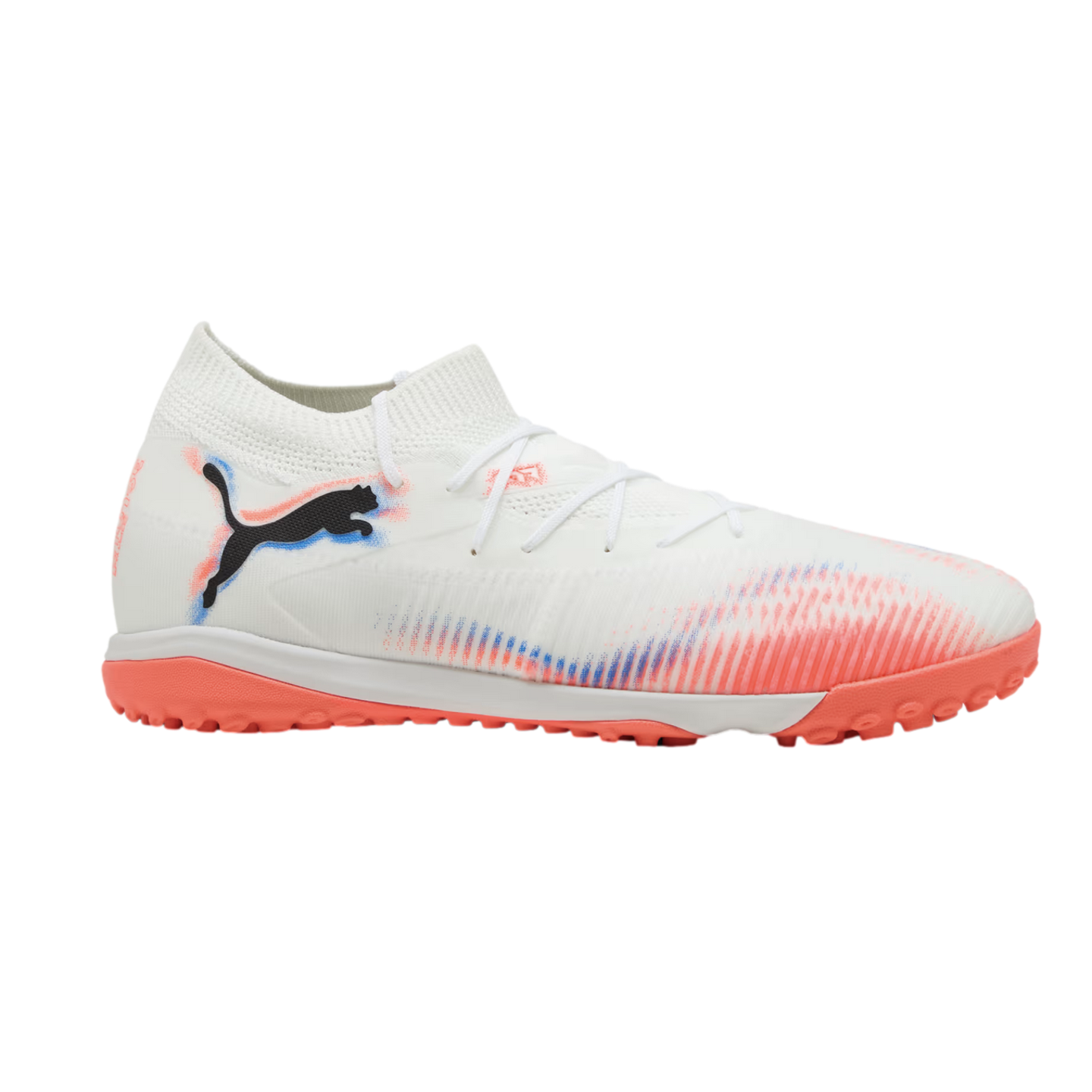 A white Puma turf soccer shoe featuring a black logo, vibrant orange and blue graphics, and an orange textured sole, set against a black background.