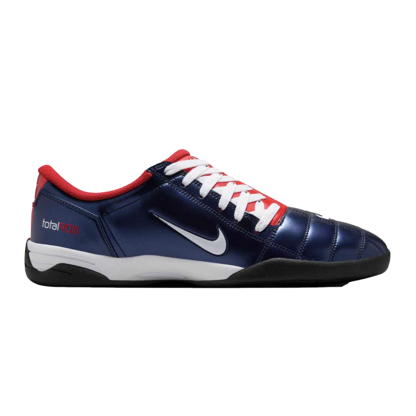 Profile view of a metallic navy blue Nike Total 90 III indoor soccer shoe with red trim, white laces, and a white swoosh, set against a black background.