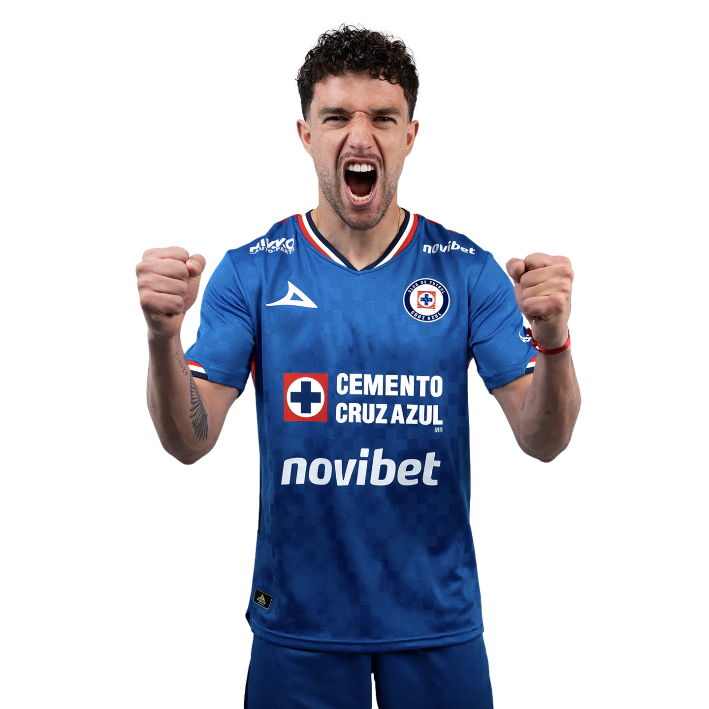 A soccer player in a blue Cruz Azul jersey shouting and clenching his fists in celebration against a solid black background.