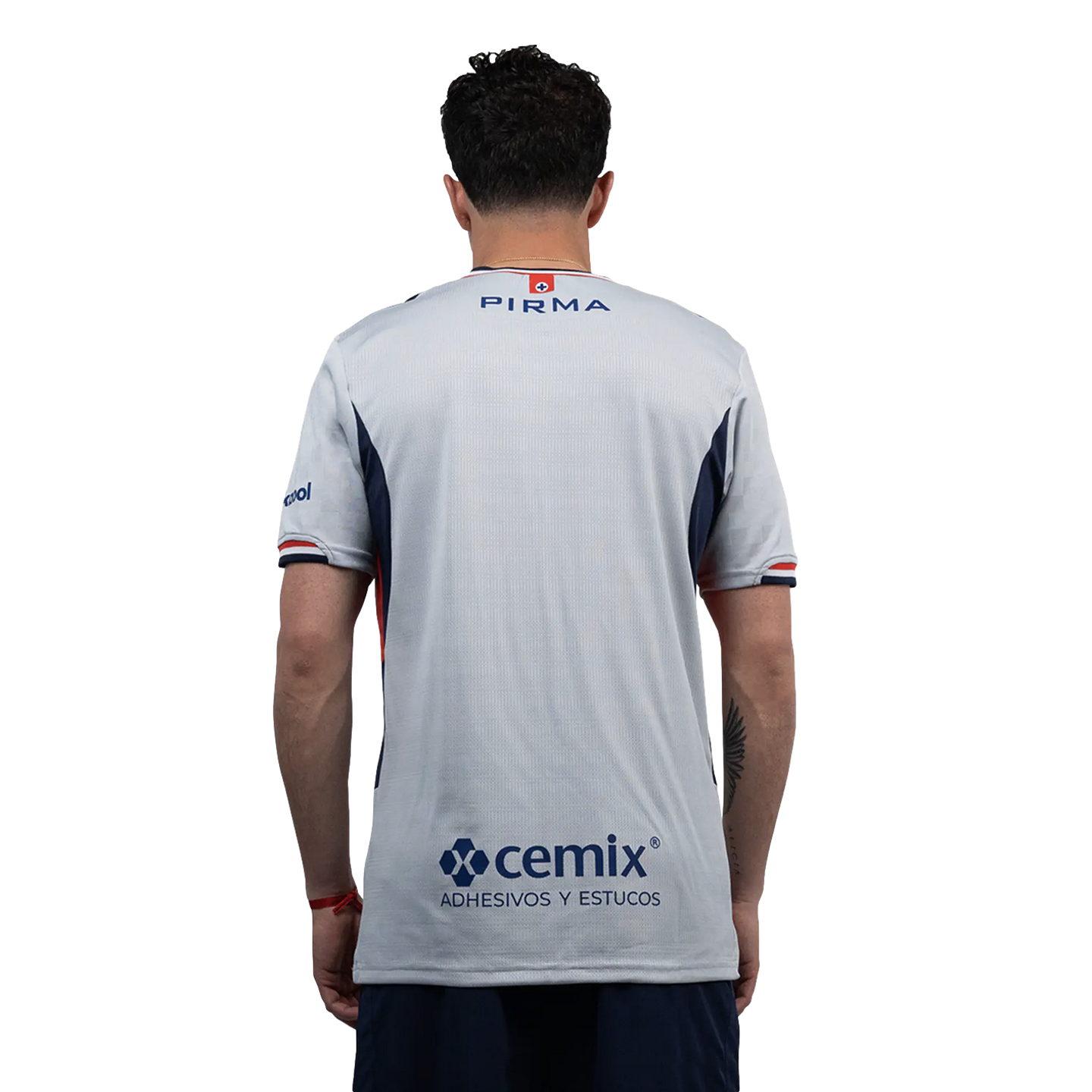 Rear view of a man wearing a light gray Pirma soccer jersey with a Cemix sponsor logo and dark blue shorts.