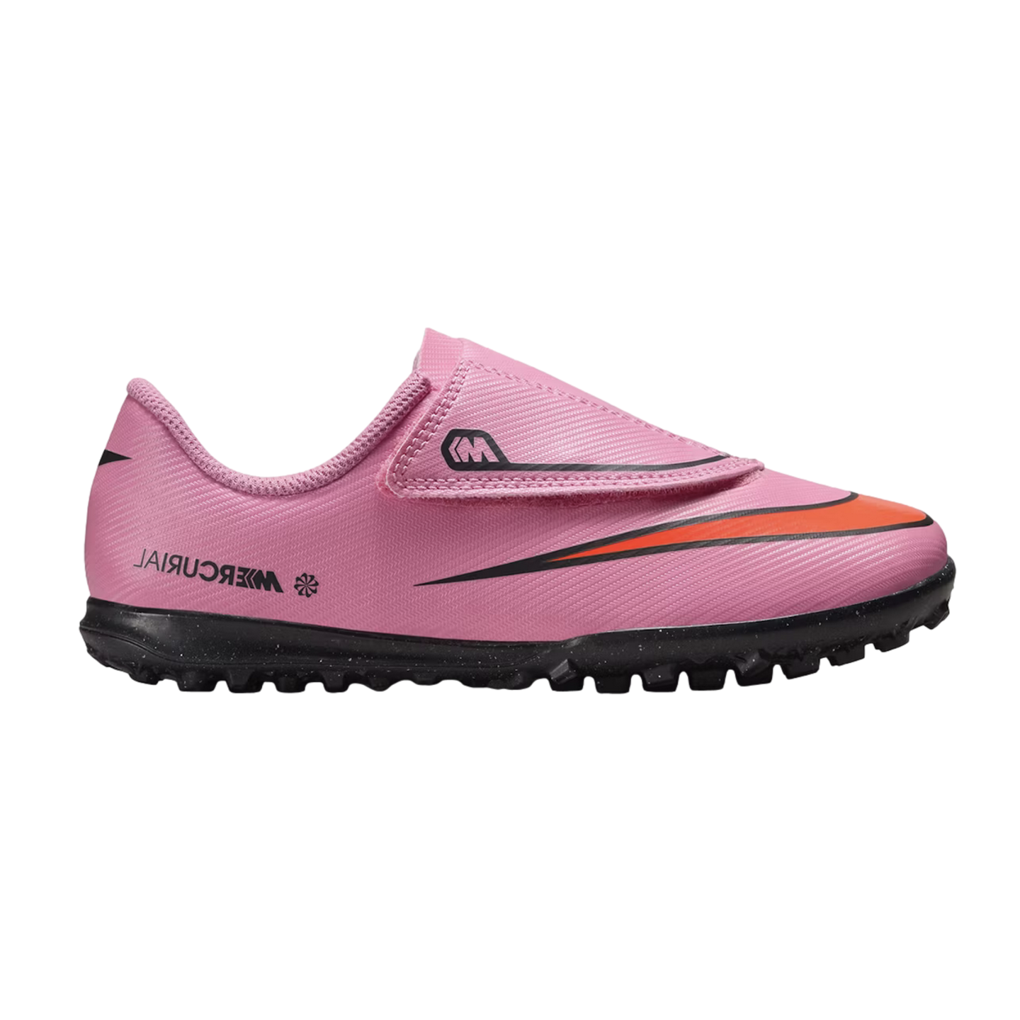 A pink Nike Mercurial turf soccer shoe with a velcro strap and orange swoosh, set against a black background.