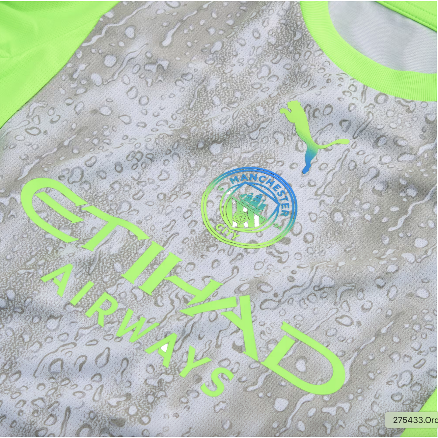 Manchester City jersey with a grey water-drop pattern and lime green accents. Features lime green 'ETIHAD AIRWAYS' logo and iridescent Puma and club crests.