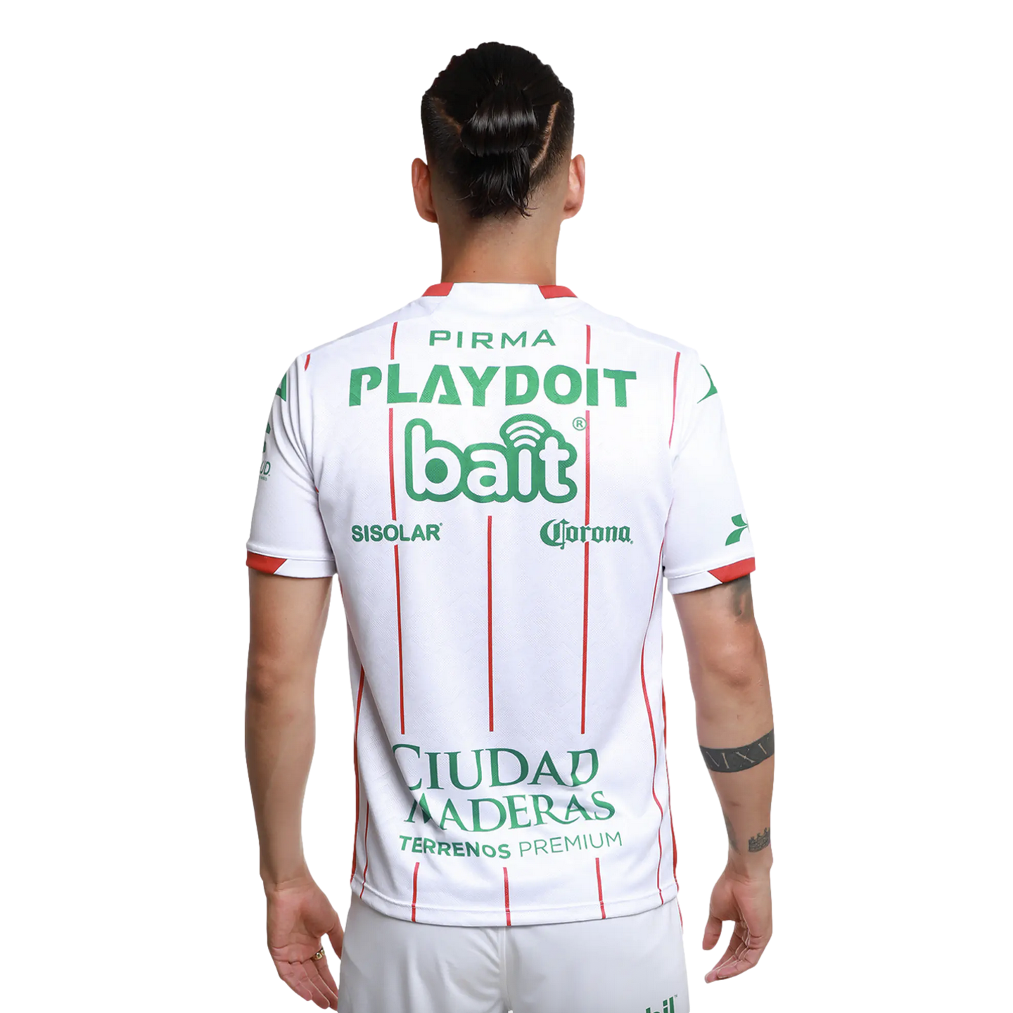 Back view of a man in a white jersey with thin red vertical stripes and green sponsor logos. His dark hair is tied in a bun.