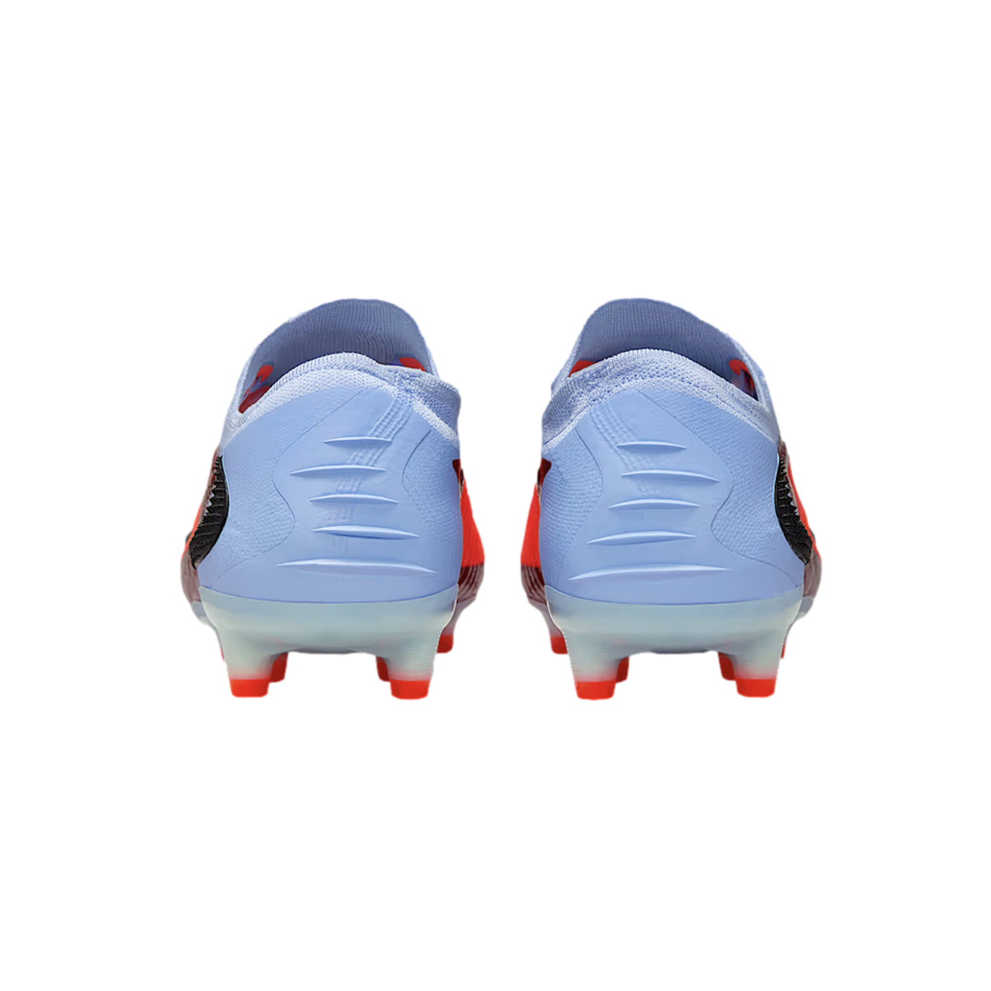 Rear view of light blue and red soccer cleats with ridged heels and bright red studs on a black background.