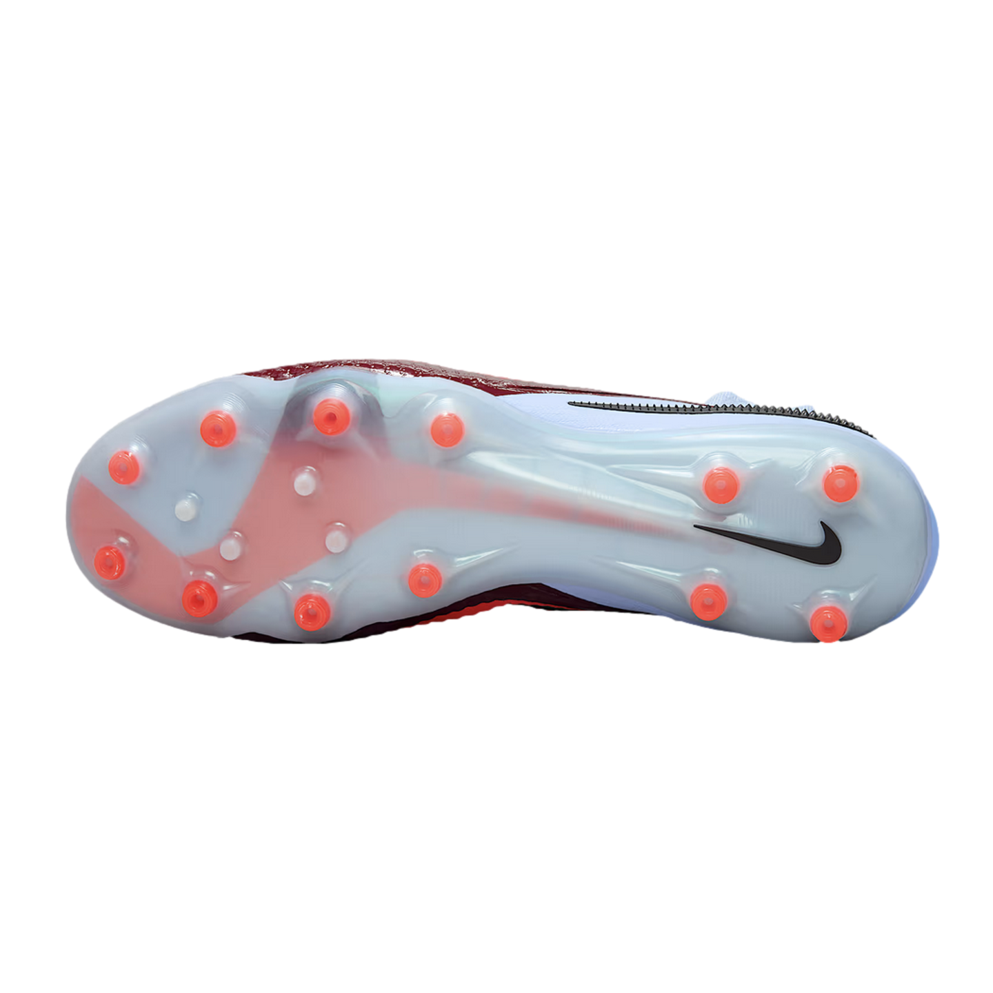 Bottom view of a Nike soccer cleat with a translucent soleplate, red and light blue accents, and orange circular studs. A black Nike swoosh is visible near the heel.