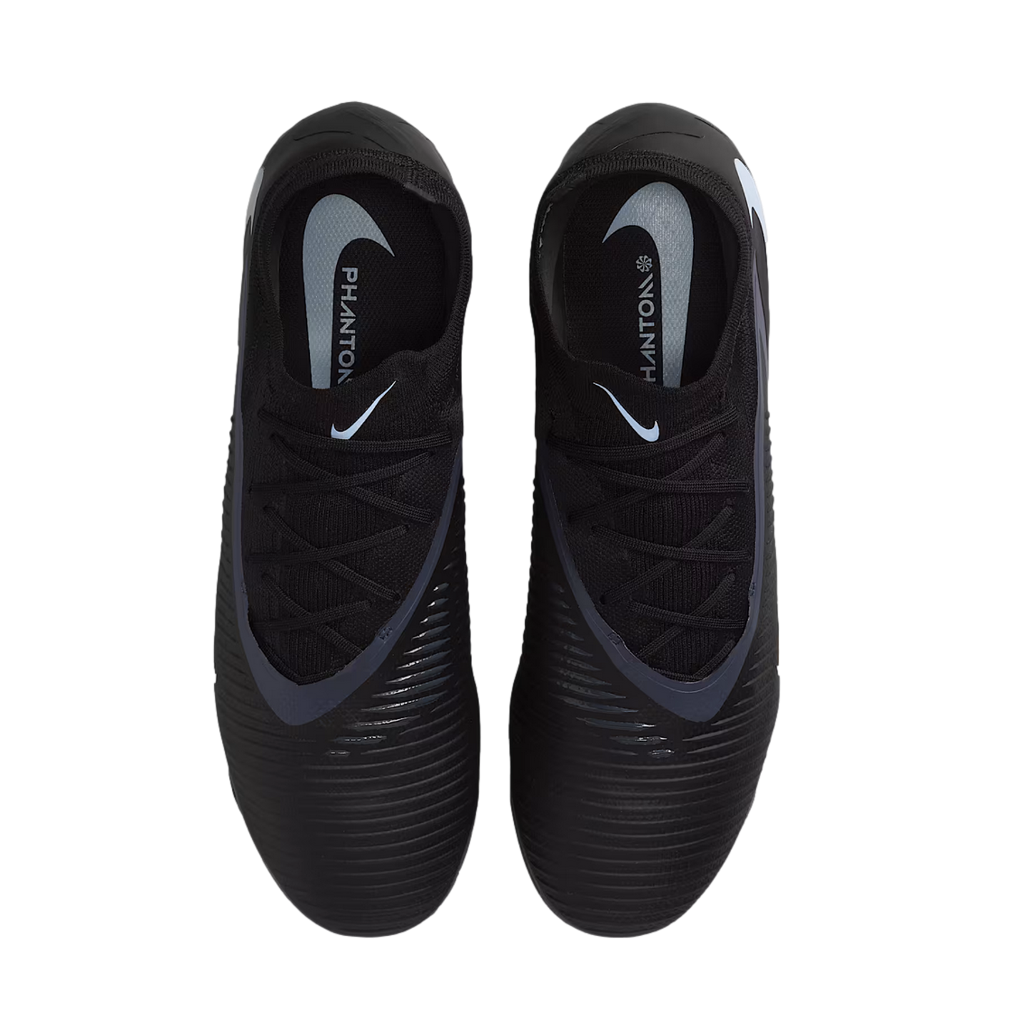 Top-down view of black Nike Phantom soccer cleats featuring textured uppers and white branding on the insoles, set against a black background.