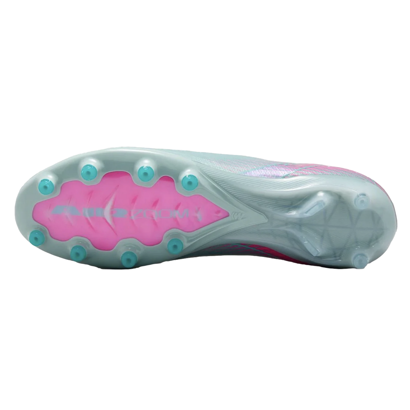 The underside of a light grey Nike soccer cleat, featuring a bright pink Air Zoom section and teal-colored conical studs.