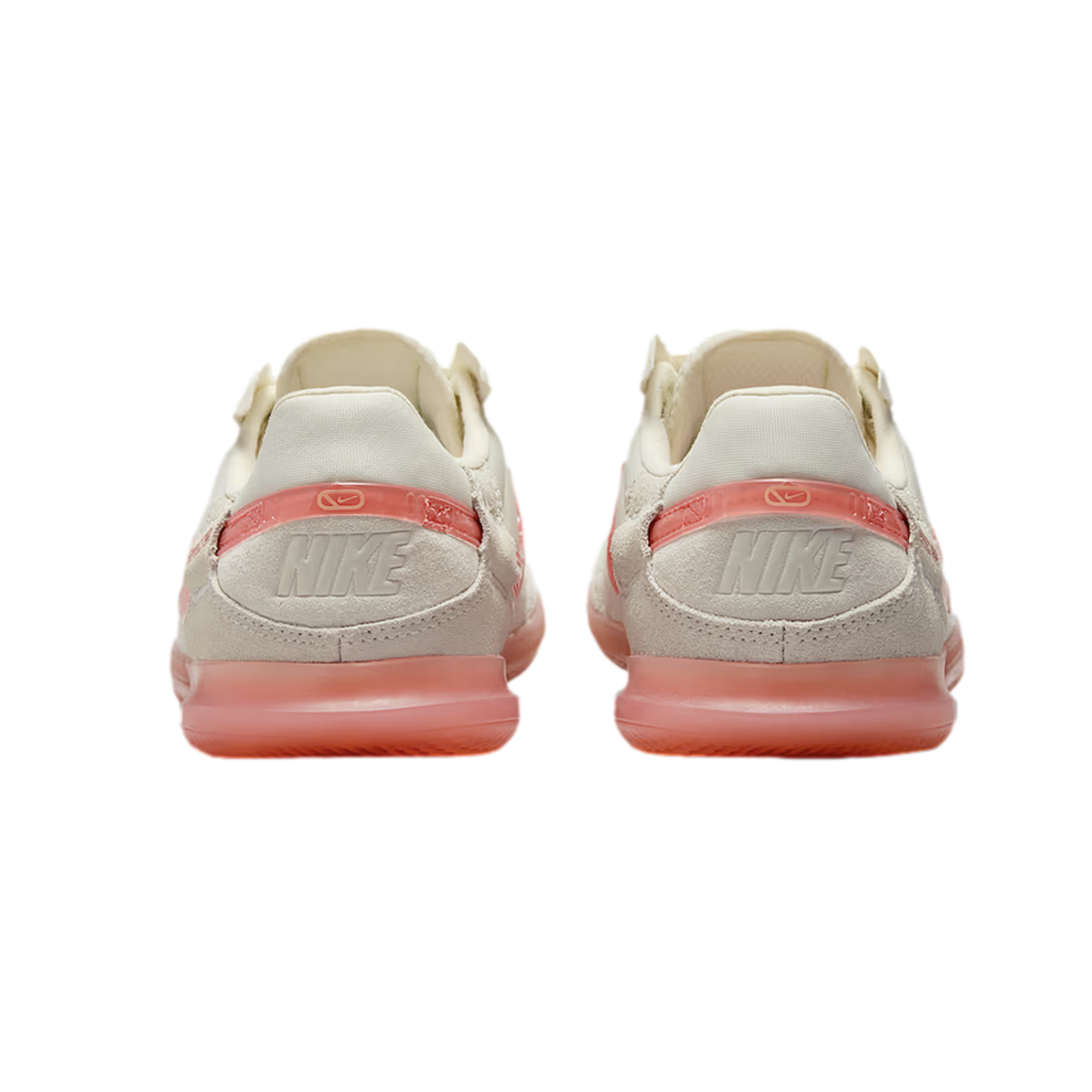 Rear view of a pair of cream Nike sneakers with translucent pink accents and heels, set against a black background.