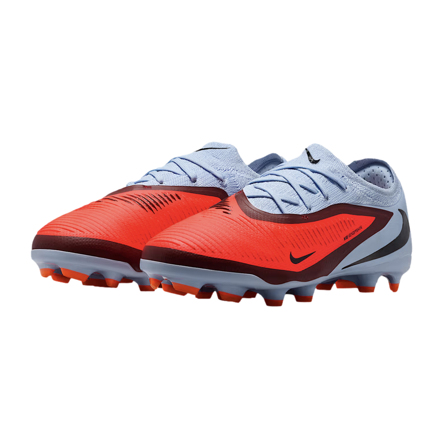 A pair of Nike Phantom Venom soccer cleats with a vibrant orange forefoot, light blue heel, and burgundy accents against a black background.