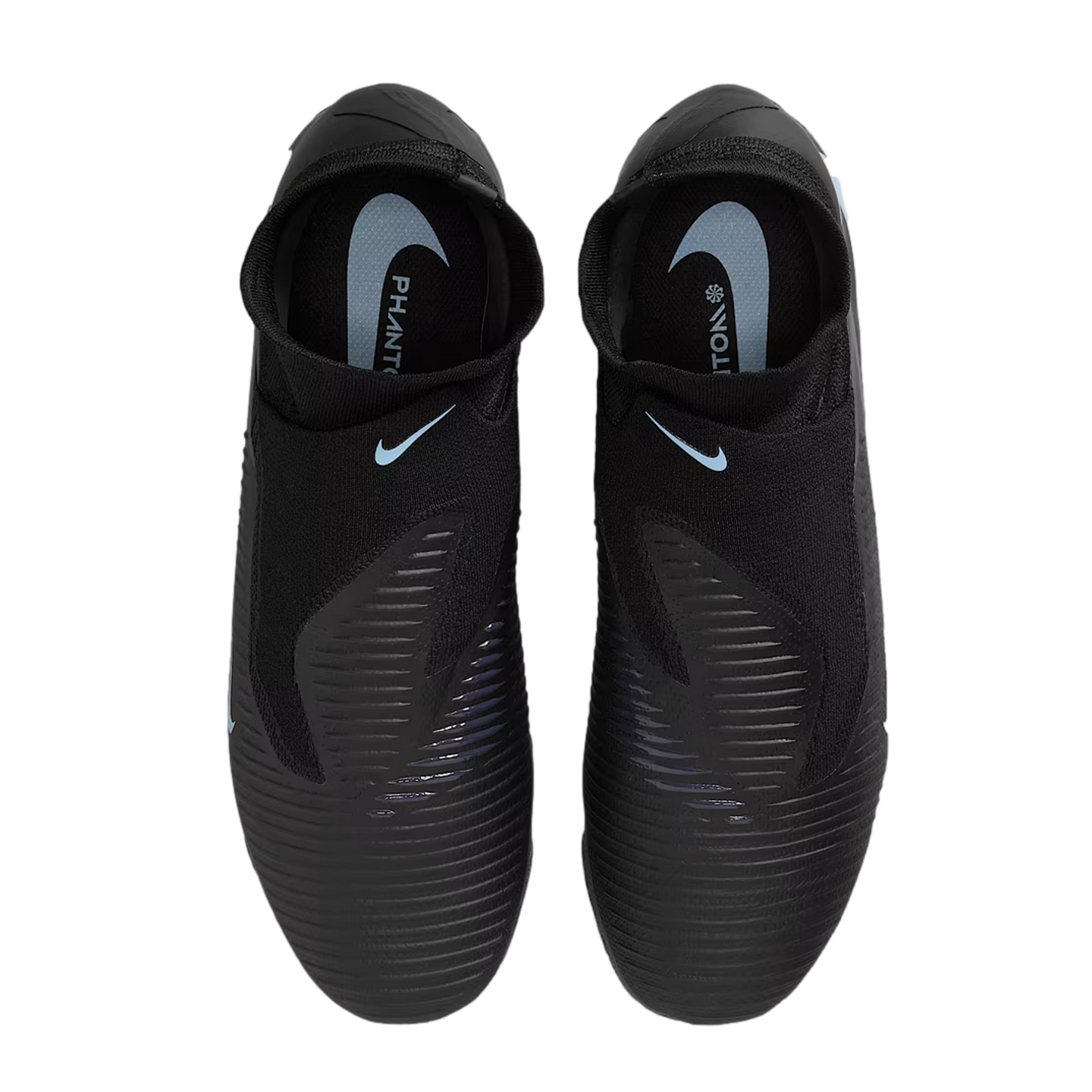 Top-down view of black Nike Phantom soccer cleats with light blue branding and ribbed texture on the upper, set against a black background.