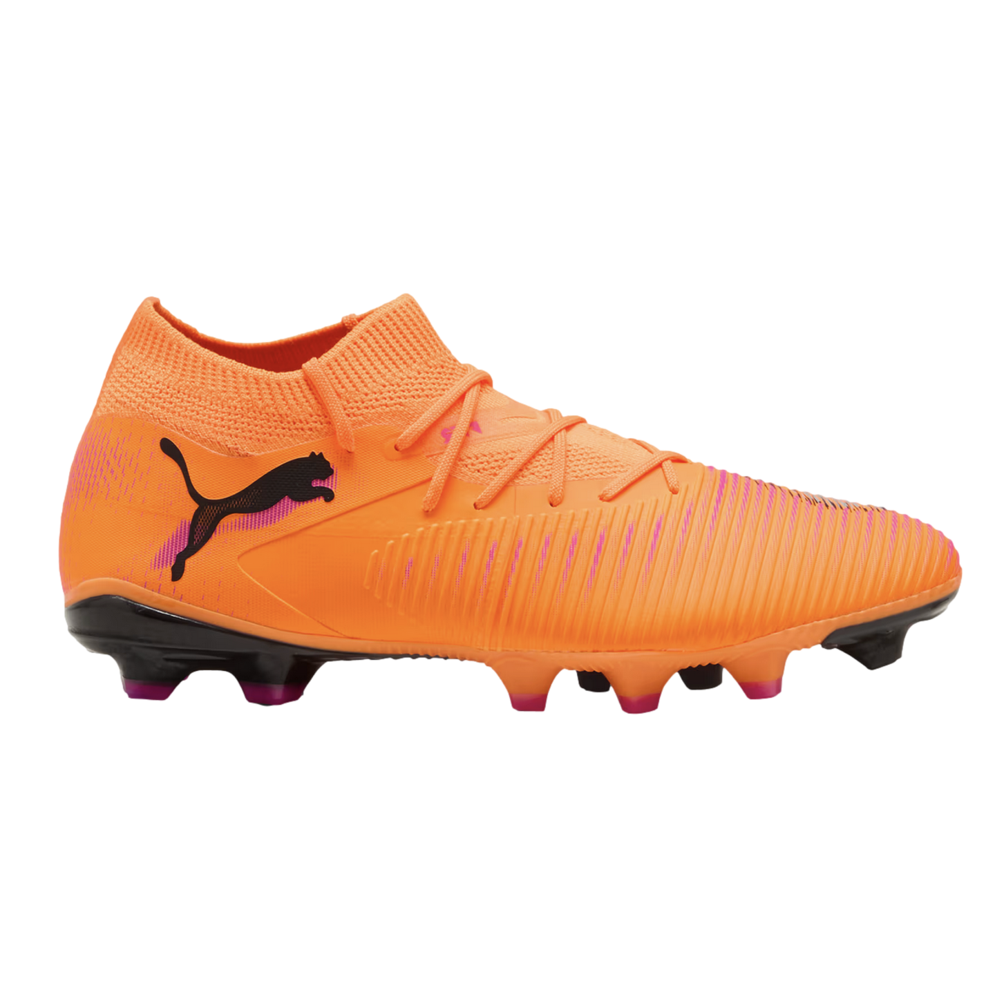 Bright orange Puma soccer boot with a black cat logo, textured upper, and sock-like collar. It features a black sole with pink-tipped studs, set against a black background.