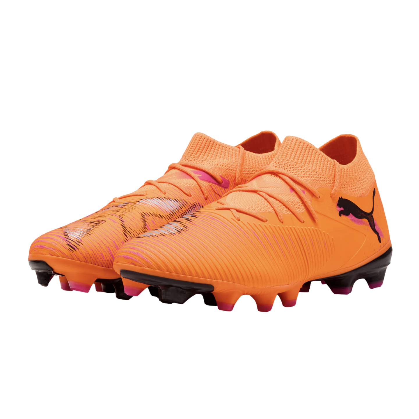 Bright orange Puma soccer cleats with pink and black accents, featuring a textured upper and knitted collar, isolated on a black background.
