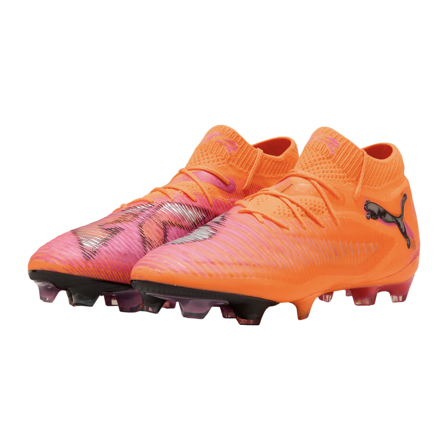 A pair of bright orange and pink Puma soccer cleats with black logos, displayed against a black background.