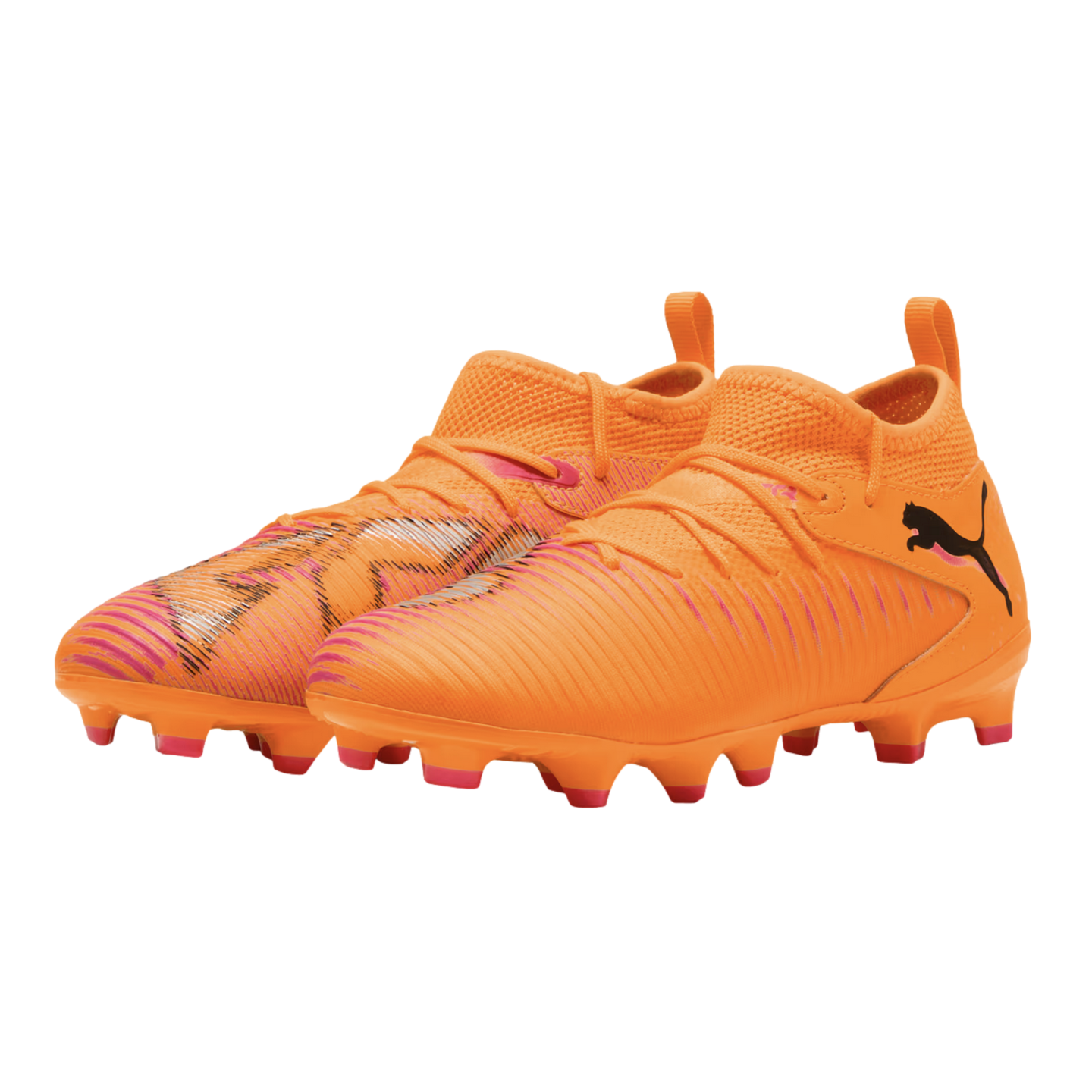 A pair of bright orange Puma soccer cleats featuring a textured upper with pink accents, a mid-cut knit collar, and a black Puma logo on the side.