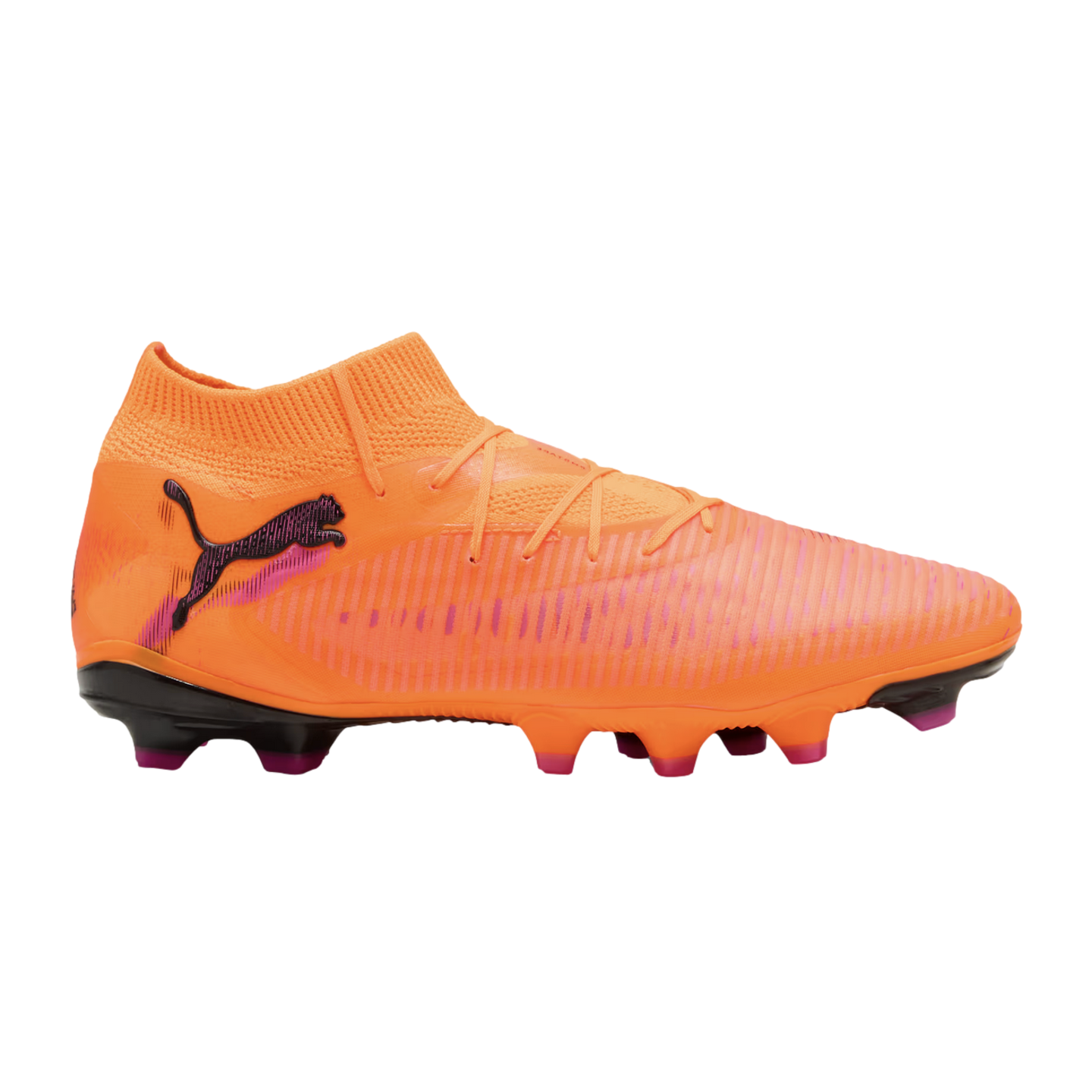An orange Puma soccer cleat with a knitted collar, textured upper, and pink accents, shown in profile against a black background.