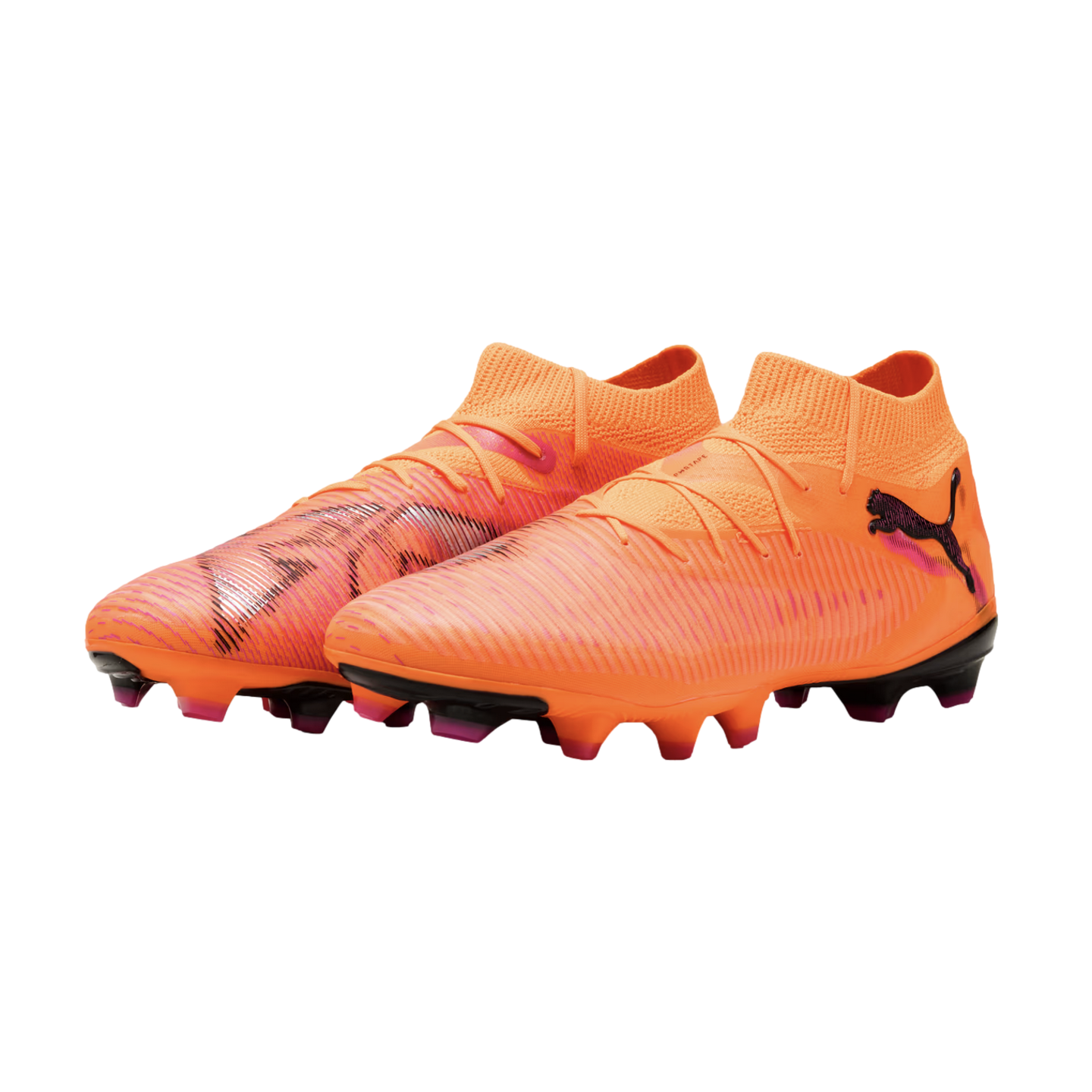 Vibrant orange Puma soccer cleats with pink and black accents, featuring a mid-cut collar and textured upper on a solid black background.