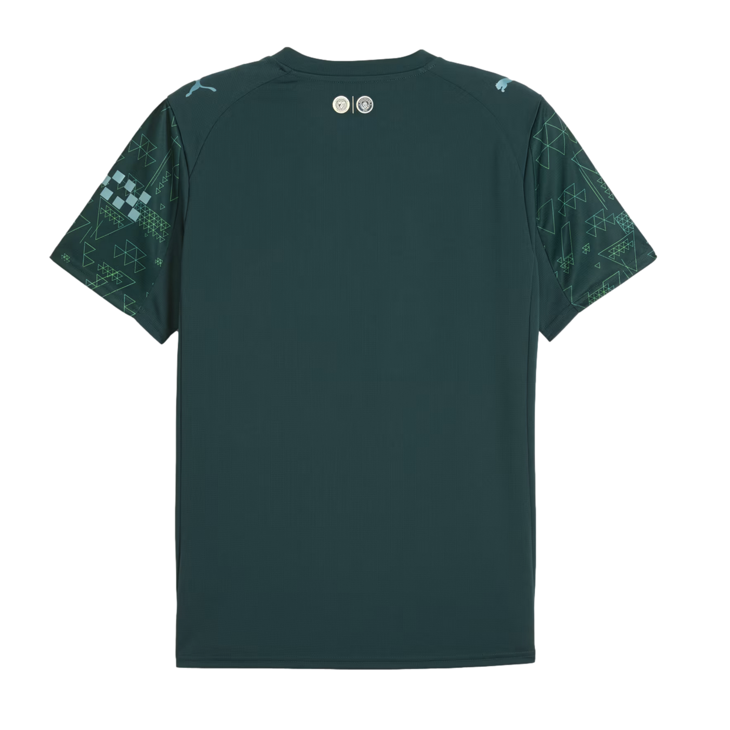 The back of a dark teal Manchester City soccer jersey featuring geometric patterned sleeves and light blue Puma logos on the shoulders.