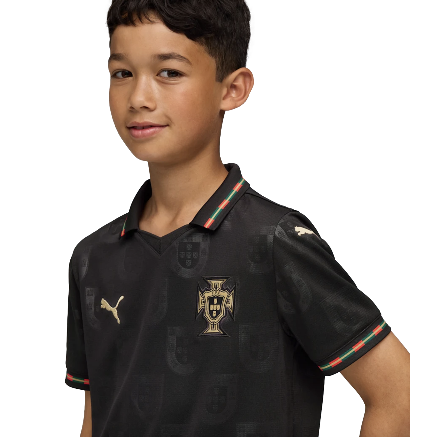 A young boy wearing a black Puma Portugal soccer jersey with gold accents and red and green trim, set against a solid black background.