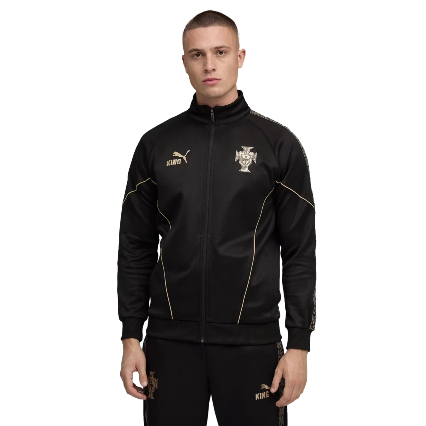 Man wearing a black Puma tracksuit with gold accents and Portugal national team crest, standing against a solid black background.