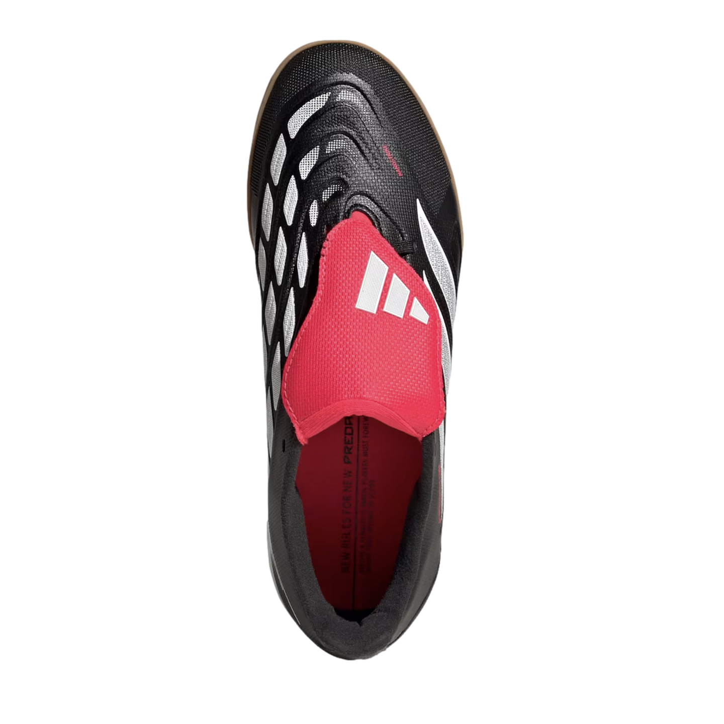 Top-down view of a black Adidas Predator indoor soccer shoe with a large red fold-over tongue and white geometric patterns against a black background.