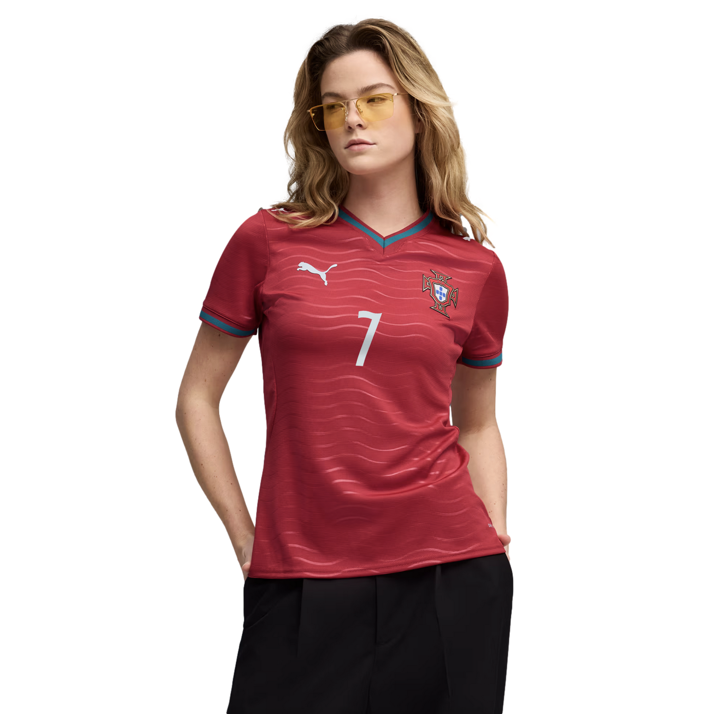 A woman wearing a red Portugal soccer jersey with the number 7 and yellow-tinted sunglasses, posing against a solid black background.