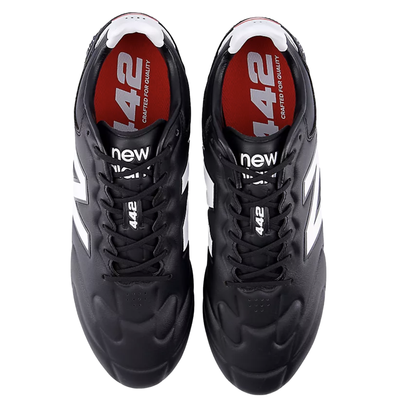 A pair of black New Balance 442 soccer cleats from a top-down perspective, featuring white logos and red insoles with white text.