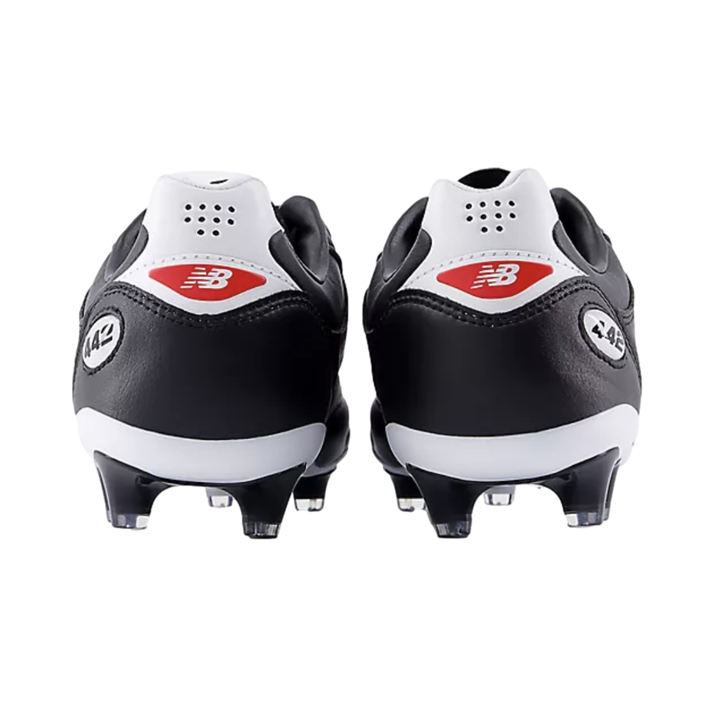 Rear view of black and white New Balance 442 soccer cleats against a black background, featuring red logos on the white heel counters.