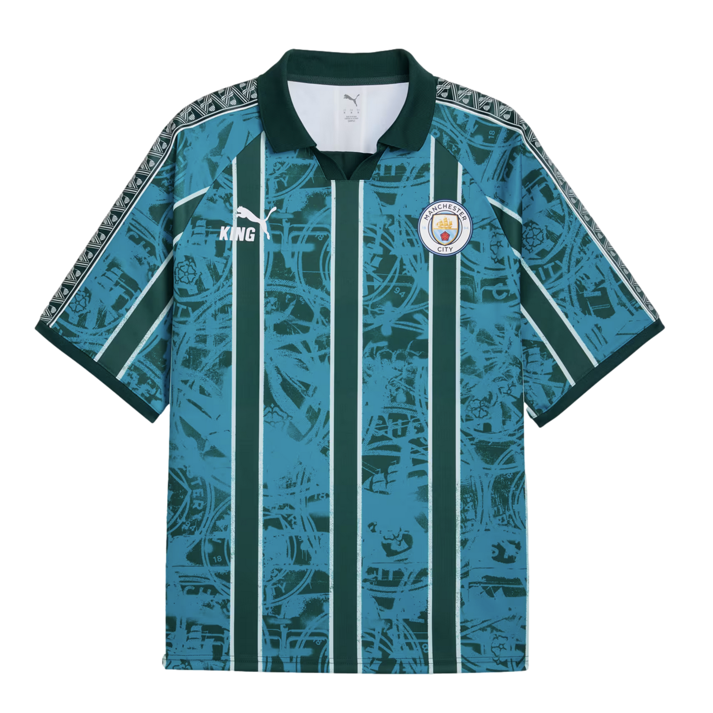 Manchester City Puma King jersey with teal and dark green vertical stripes over a distressed crest graphic. Features a dark green collar and patterned trim on the shoulders and sleeves.