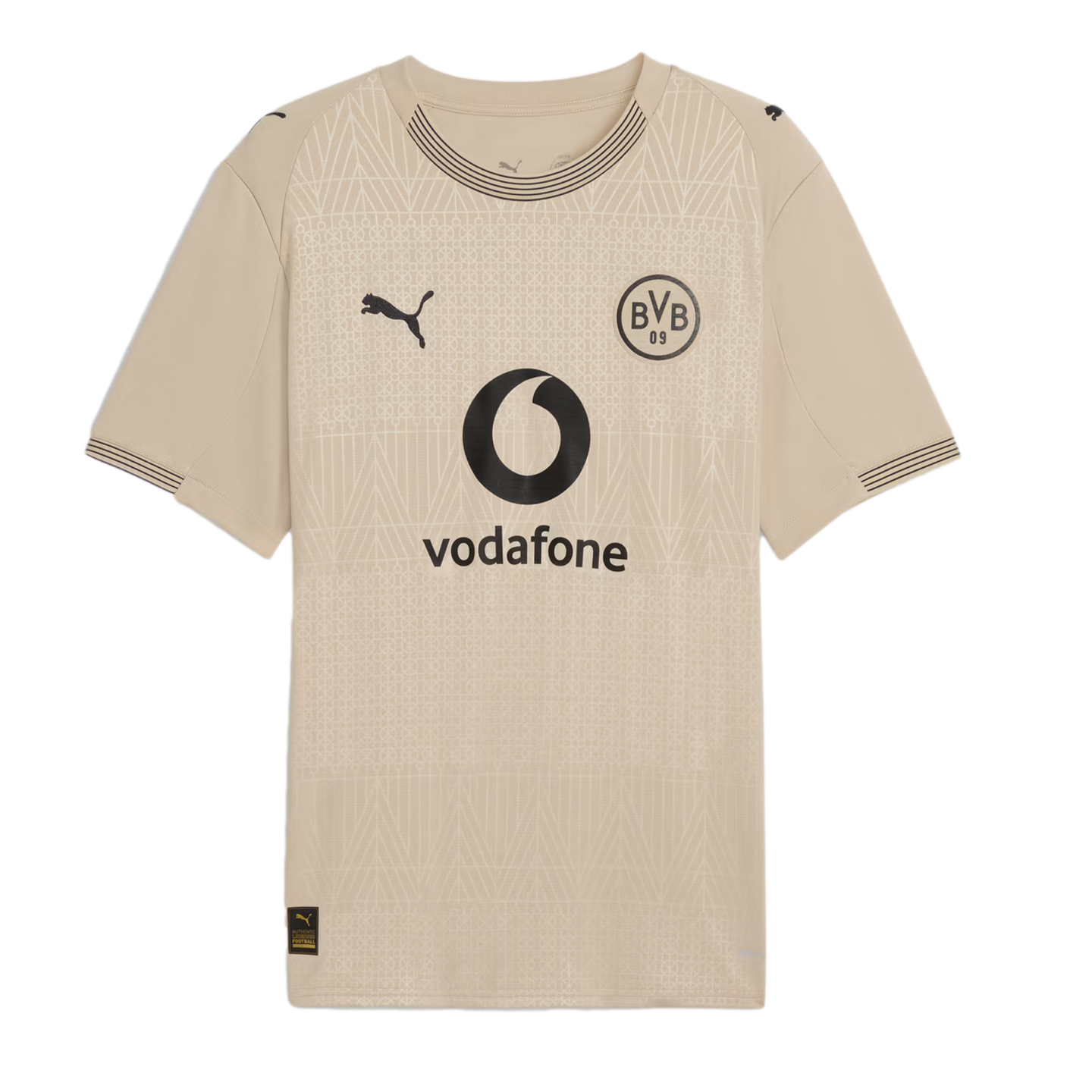 Beige Puma soccer jersey with a black BVB crest and Vodafone logo. Subtle geometric patterns cover the shirt, which has striped details on the collar and cuffs.