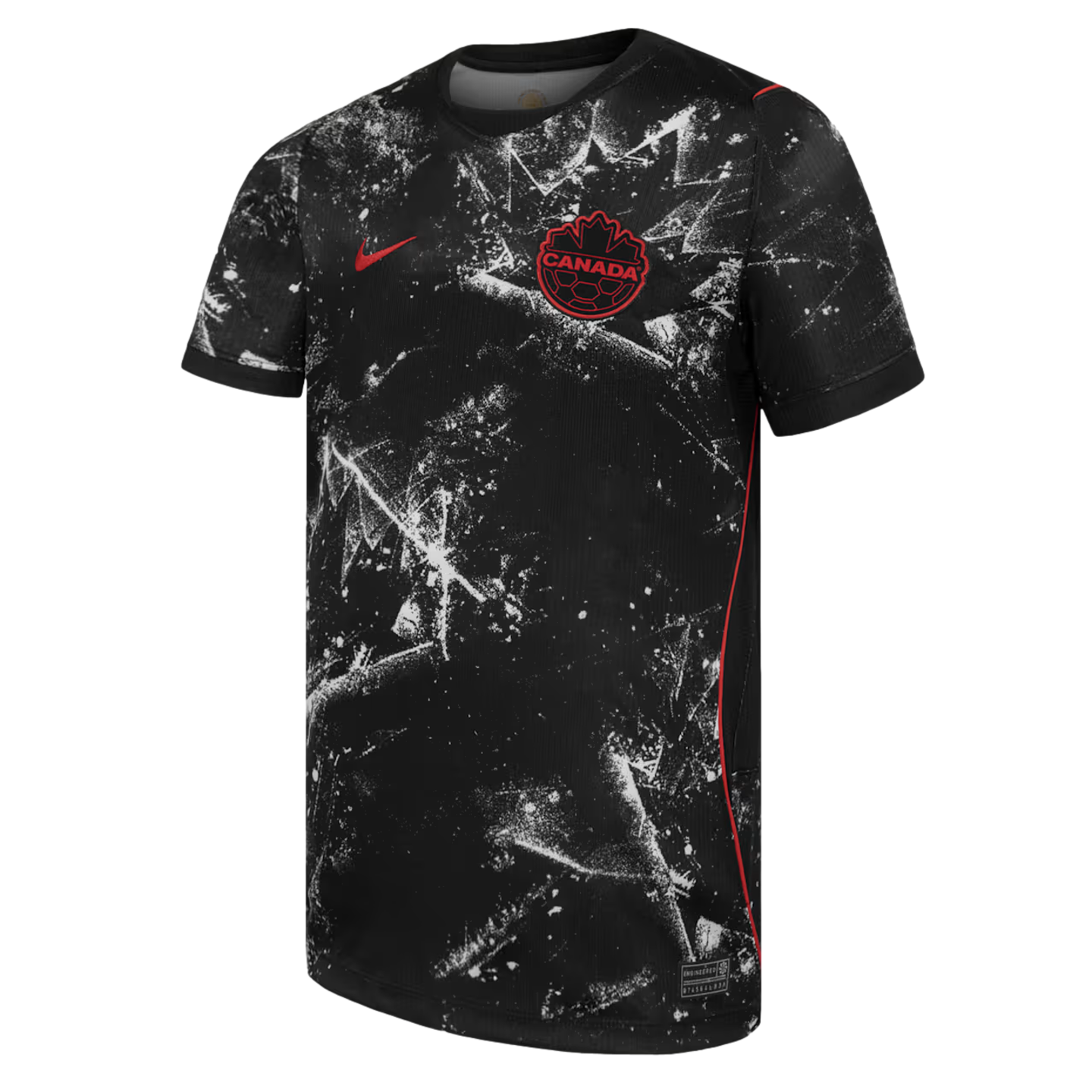 A black short-sleeved Canada national soccer team jersey featuring a white splatter pattern that forms large, stylized maple leaf motifs. A red Nike swoosh is on the right chest, and a red and black circular Canada Soccer crest with "CANADA" text is on th