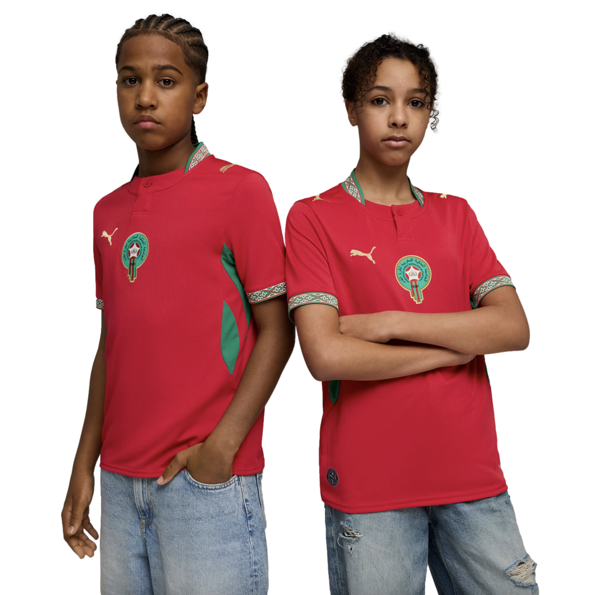 Two young people pose side-by-side against a black background, wearing red Moroccan national football team jerseys and light-wash denim jeans.