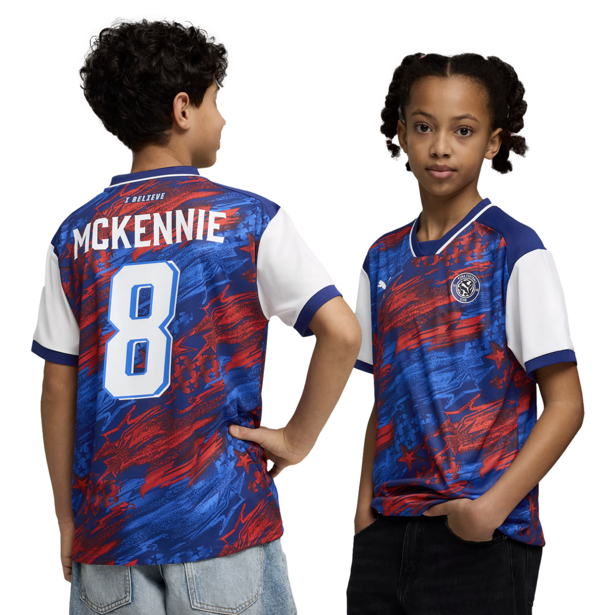 A boy and a girl model a red, blue, and white abstract-patterned soccer jersey against a black background. The boy on the left shows the back of the shirt, which features the name "MCKENNIE" and the number "8" in white. The girl on the right shows the fro