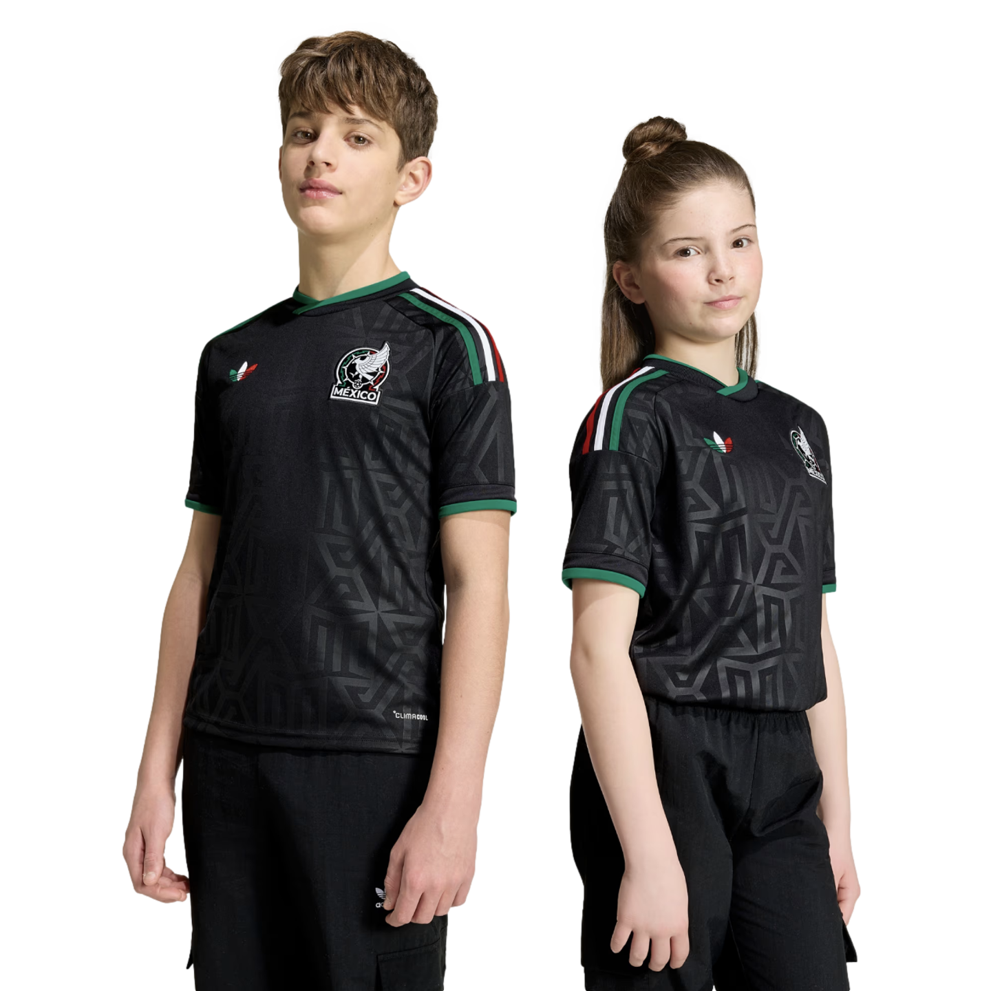 A boy and girl stand side-by-side wearing matching black Mexico national soccer team jerseys with green trim and geometric patterns against a white background.