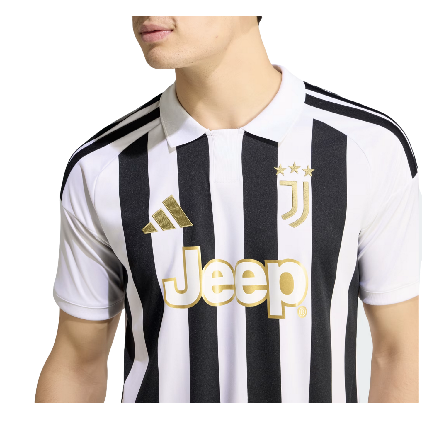 A person wearing a black and white striped Juventus home jersey with gold-toned logos and a white polo collar.